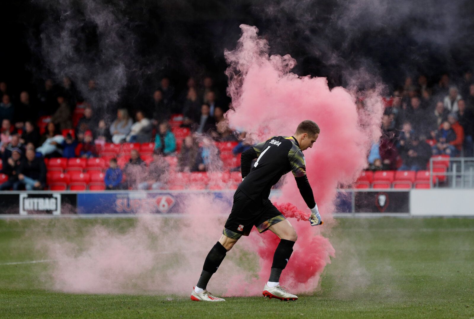 Soccer Football - League Two - Salford City v Swindon Town - The Peninsula Stadium, Salford, Britain - November 16, 2019   Swindon Town's Steven Benda removes a flare following Salford City's first goal    Action Images/Lee Smith    EDITORIAL USE ONLY. No use with unauthorized audio, video, data, fixture lists, club/league logos or 