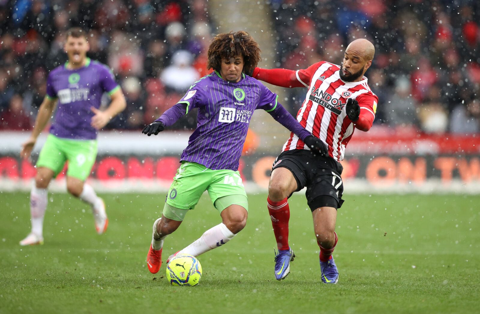 Soccer Football - Championship - Sheffield United v Bristol City - Bramall Lane, Sheffield, Britain - November 28, 2021 Bristol City's Han-Noah Massengo in action with Sheffield United's David McGoldrick Action Images/Molly Darlington EDITORIAL USE ONLY. No use with unauthorized audio, video, data, fixture lists, club/league logos or 'live' services. Online in-match use limited to 75 images, no video emulation. No use in betting, games or single club /league/player publications.  Please contact 
