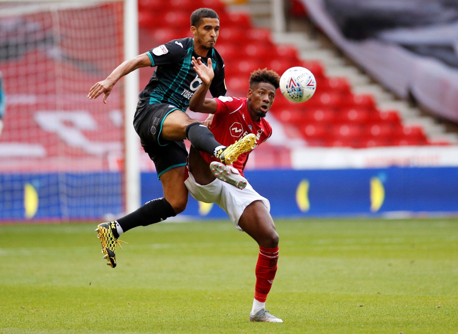 Soccer Football - Championship - Nottingham Forest v Swansea City - The City Ground, Nottingham, Britain - July 15, 2020   Swansea City's Kyle Naughton in action with Nottingham Forest's Nuno Da Costa, as play resumes behind closed doors following the outbreak of the coronavirus disease (COVID-19)   Action Images/Andrew Boyers    EDITORIAL USE ONLY. No use with unauthorized audio, video, data, fixture lists, club/league logos or 