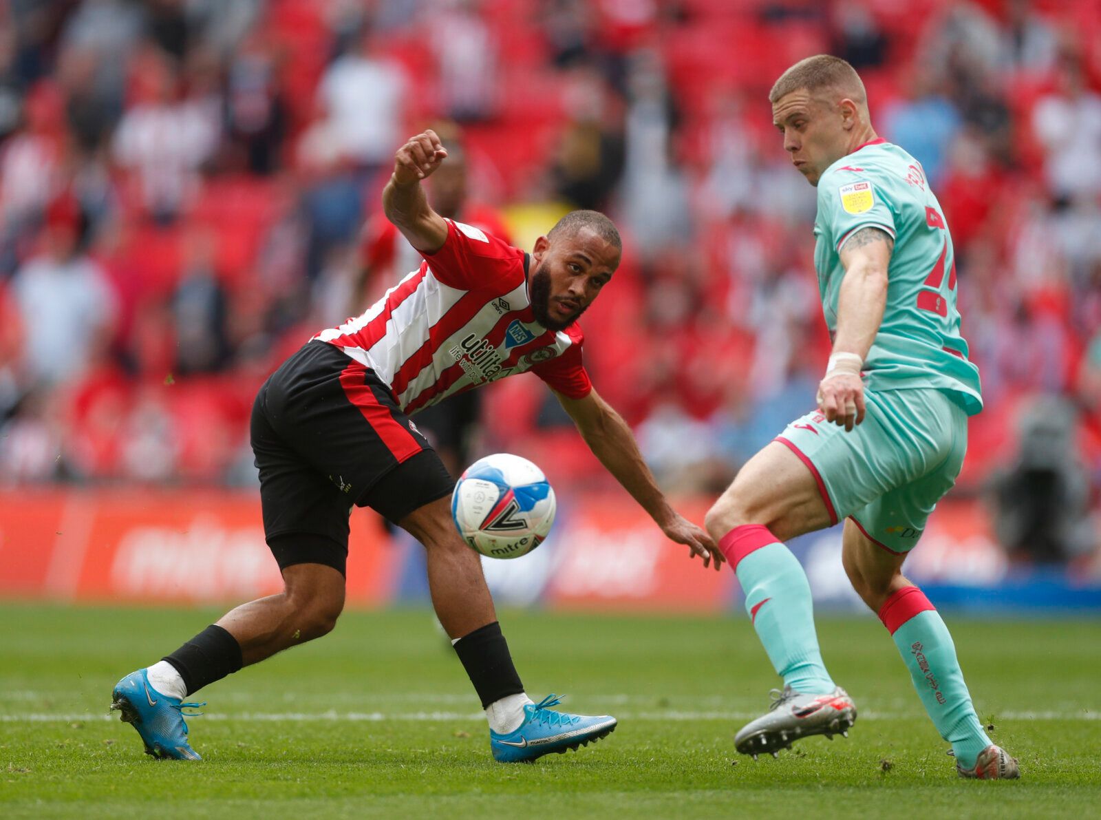 Soccer Football - Championship Play-Off Final - Brentford v Swansea City - Wembley Stadium, London, Britain - May 29, 2021 Brentford's Bryan Mbeumo in action with Swansea City's Jake Bidwell Action Images via Reuters/Matthew Childs