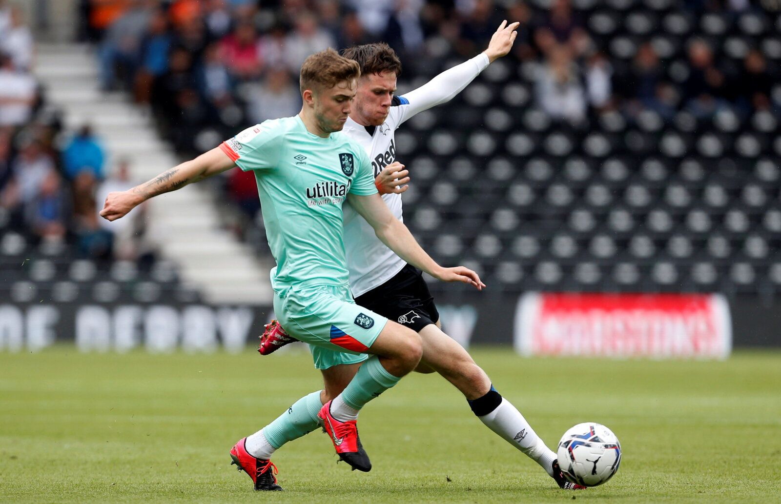 Soccer Football - Championship - Derby County v Huddersfield Town - Pride Park, Derby, Britain - August 7, 2021 Huddersfield Town's Scott High in action with Derby County's Max Bird   Action Images/Craig Brough