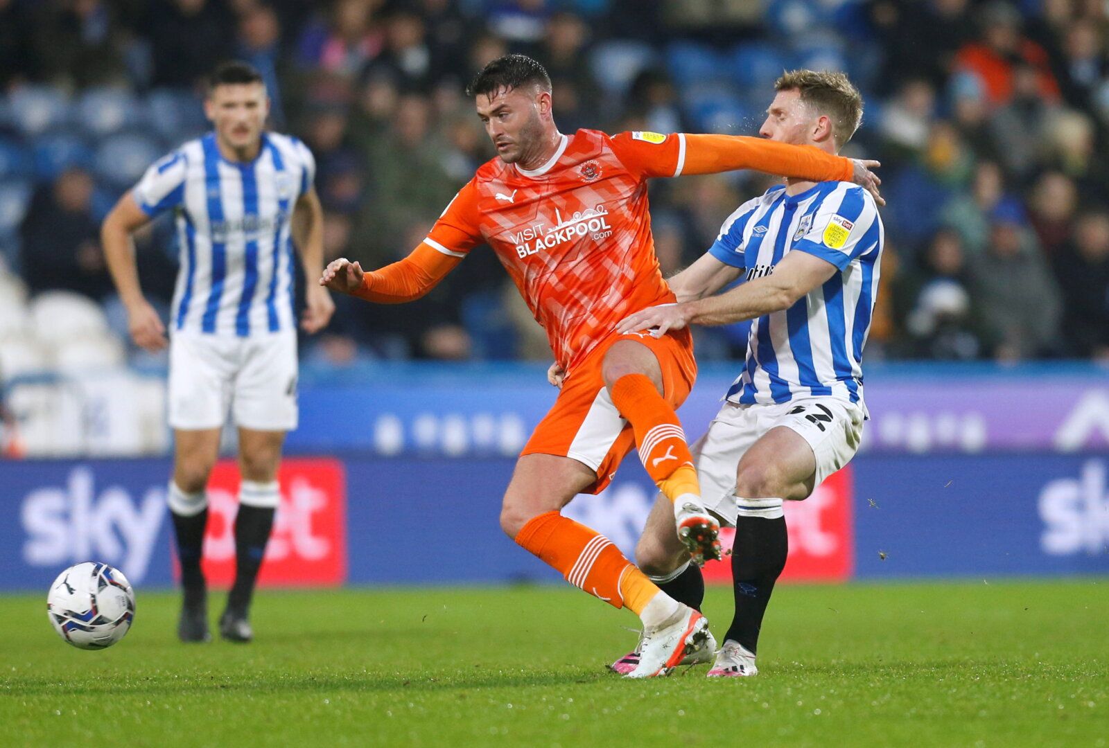 Soccer Football - Championship - Huddersfield Town v Blackpool - John Smith's Stadium, Huddersfield, Britain - December 26, 2021 Blackpool's Gary Madine in action with Huddersfield Town's Tom Lees   Action Images via Reuters/Ed Sykes  EDITORIAL USE ONLY. No use with unauthorized audio, video, data, fixture lists, club/league logos or 