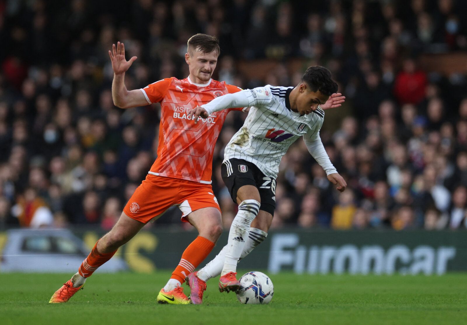 Soccer Football - Championship - Fulham v Blackpool - Craven Cottage, London, Britain - January 29, 2022 Blackpool's Callum Connolly in action with Fulham's Fabio Carvalho Action Images/Paul Childs EDITORIAL USE ONLY. No use with unauthorized audio, video, data, fixture lists, club/league logos or 'live' services. Online in-match use limited to 75 images, no video emulation. No use in betting, games or single club /league/player publications.  Please contact your account representative for furth