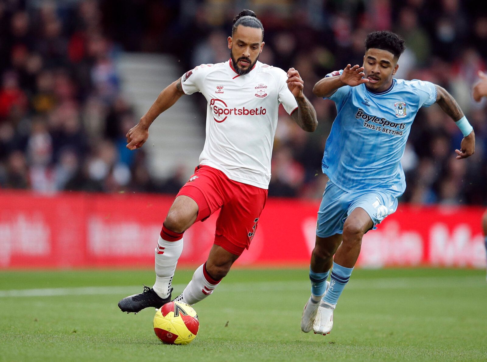 Soccer Football - FA Cup - Fourth Round - Southampton v Coventry City - St Mary's Stadium, Southampton, Britain - February 5, 2022 Southampton's Theo Walcott in action with Coventry City's Ian Maatsen REUTERS/Peter Nicholls