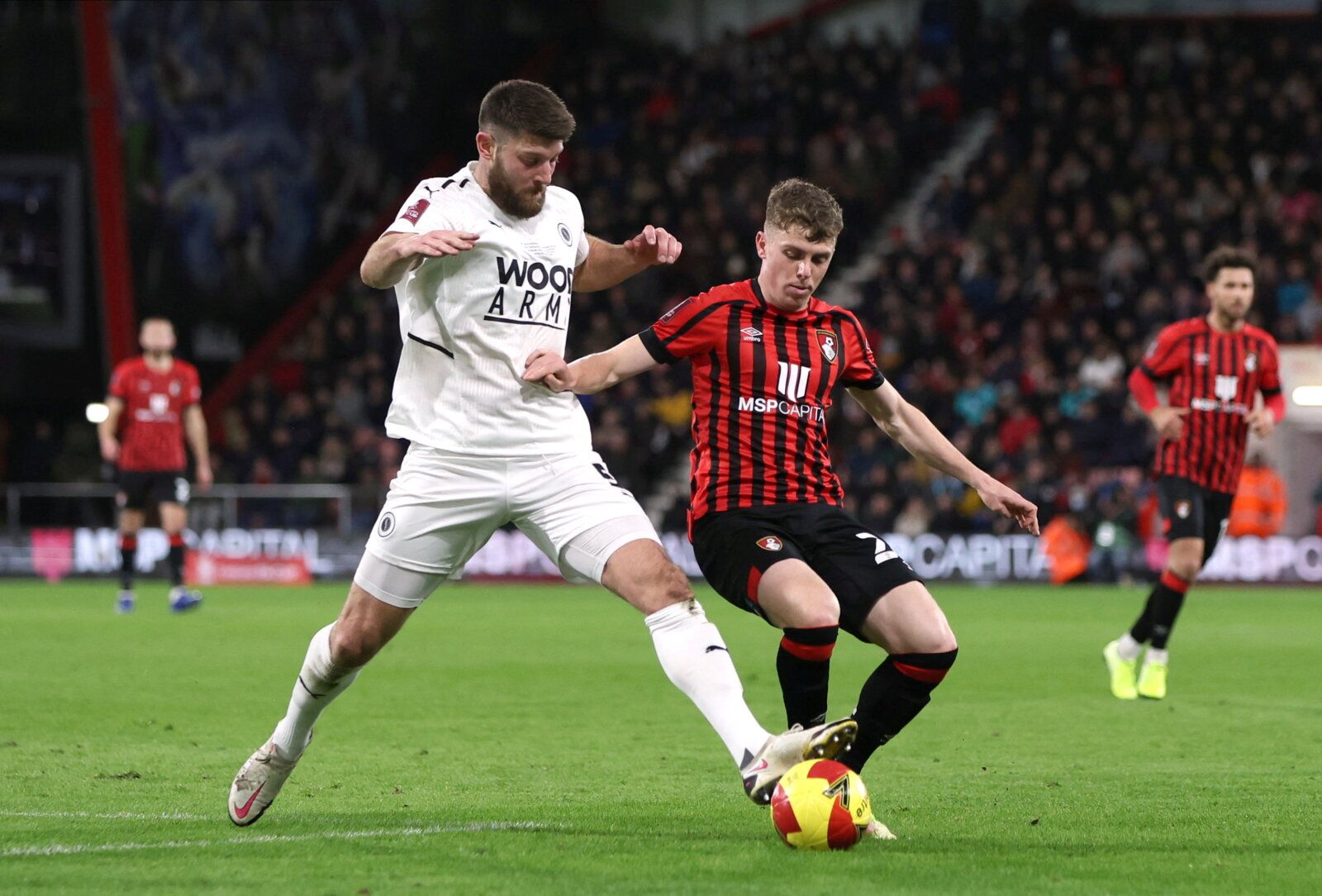 Soccer Football - FA Cup - Fourth Round - AFC Bournemouth v Boreham Wood - Vitality Stadium, Bournemouth, Britain - February 6, 2022 Boreham Wood's Will Evans in action with Bournemouth's Gavin Kilkenny Action Images/Paul Childs