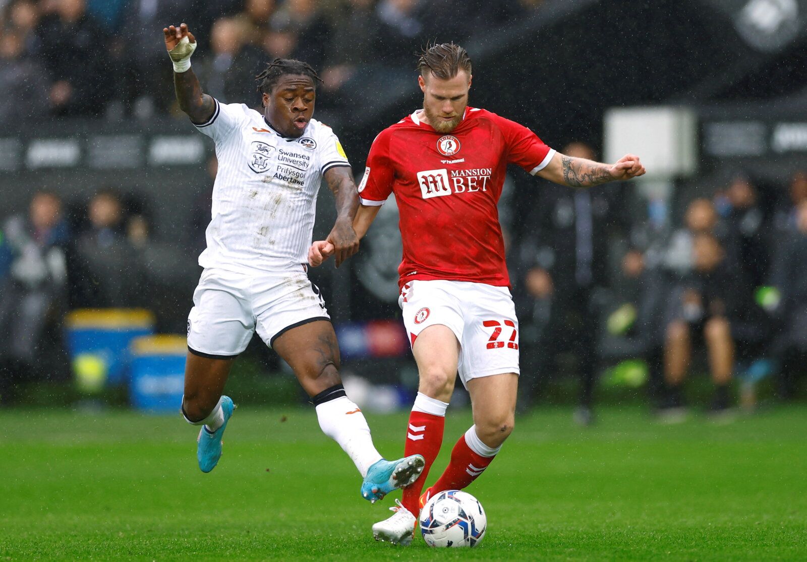Soccer Football - Championship - Swansea City v Bristol City - Swansea.com Stadium, Swansea, Britain - February 13, 2022 Swansea City's Michael Obafemi in action with Bristol City's Tomas Kalas    Action Images/Andrew Boyers  EDITORIAL USE ONLY. No use with unauthorized audio, video, data, fixture lists, club/league logos or 