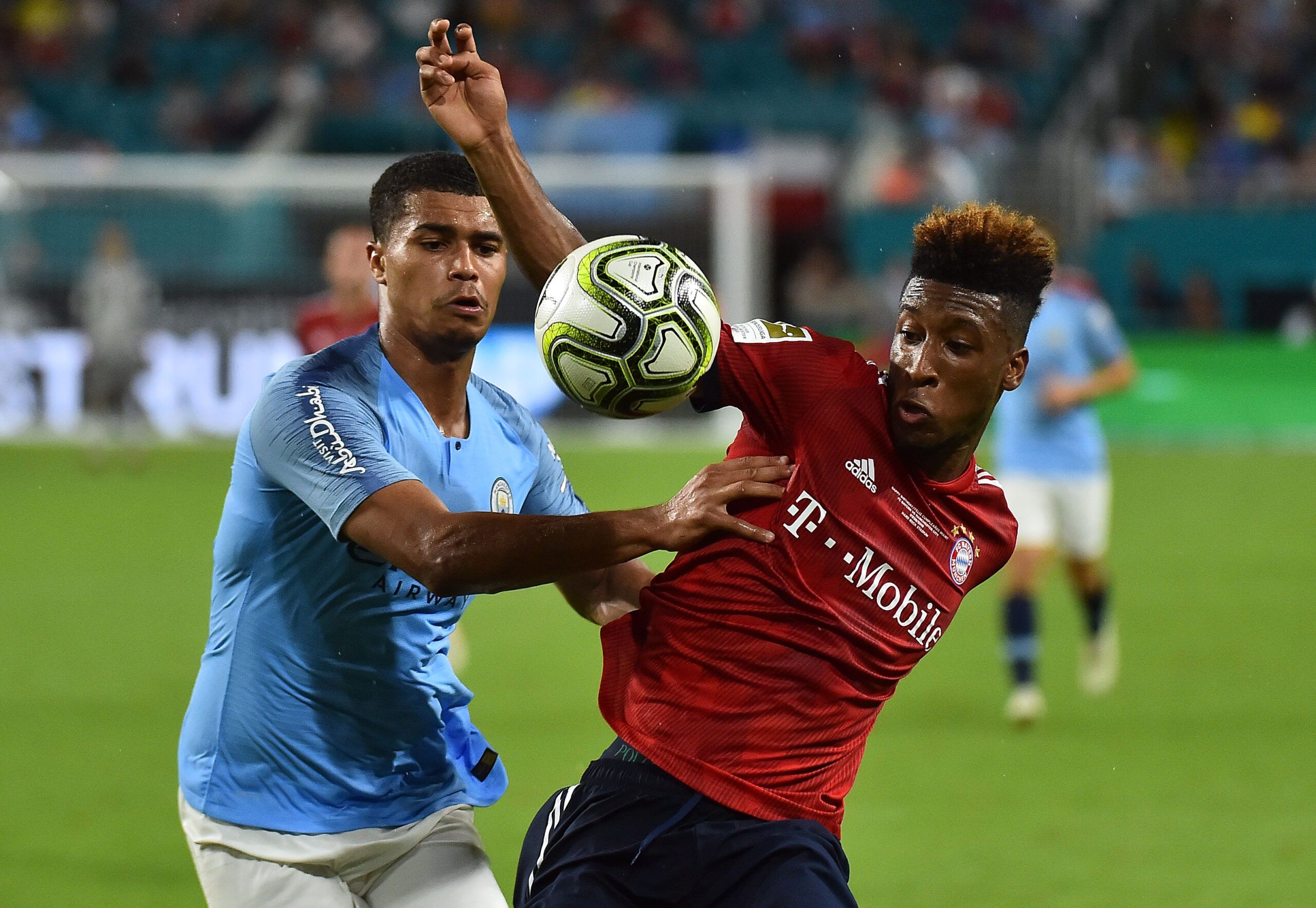 Jul 28, 2018; Miami, FL, USA; Bayern Munich midfielder Kingsley Coman (29) and Manchester City defender Cameron Humphreys (77) battle for the ball during the second half of an International Champions Cup soccer match at Hard Rock Stadium. Mandatory Credit: Jasen Vinlove-USA TODAY Sports