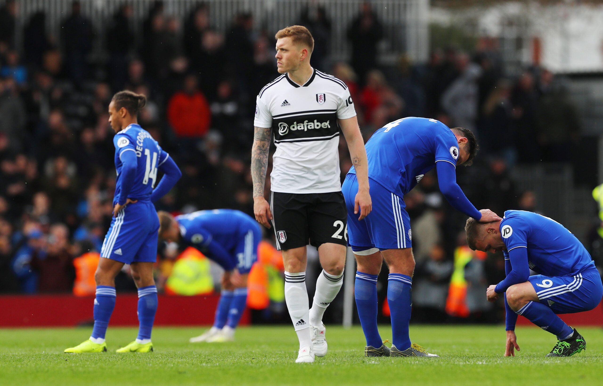 Soccer Football - Premier League - Fulham v Cardiff City - Craven Cottage, London, Britain - April 27, 2019  Fulham's Alfie Mawson looks on after the match as Cardiff City players look dejected          REUTERS/Eddie Keogh  EDITORIAL USE ONLY. No use with unauthorized audio, video, data, fixture lists, club/league logos or 