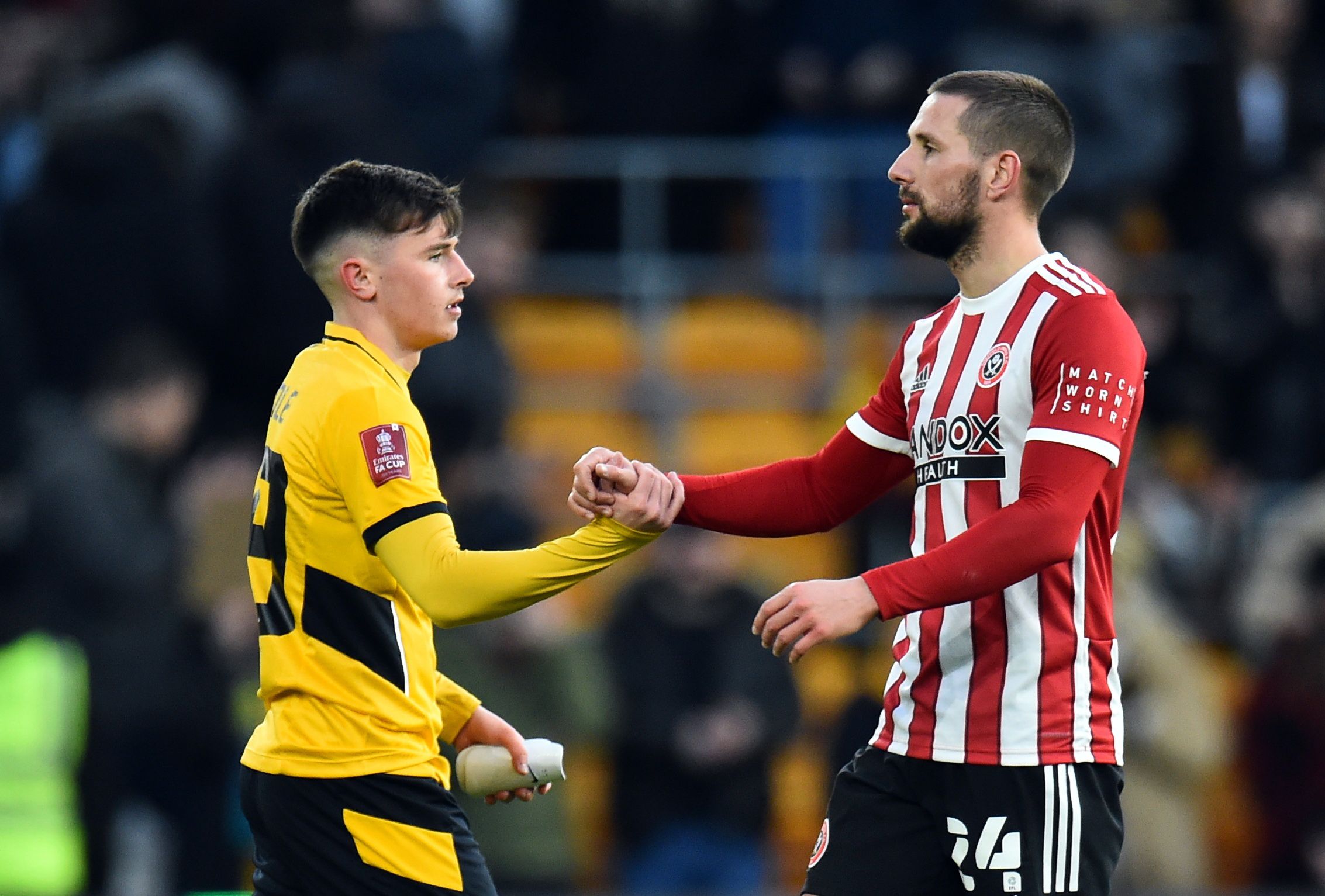 Soccer Football - FA Cup Third Round - Wolverhampton Wanderers v Sheffield United - Molineux Stadium, Wolverhampton, Britain - January 9, 2022 Wolverhampton Wanderers' Luke Cundle shakes hands with Sheffield United's Conor Hourihane after the match REUTERS/Peter Powell