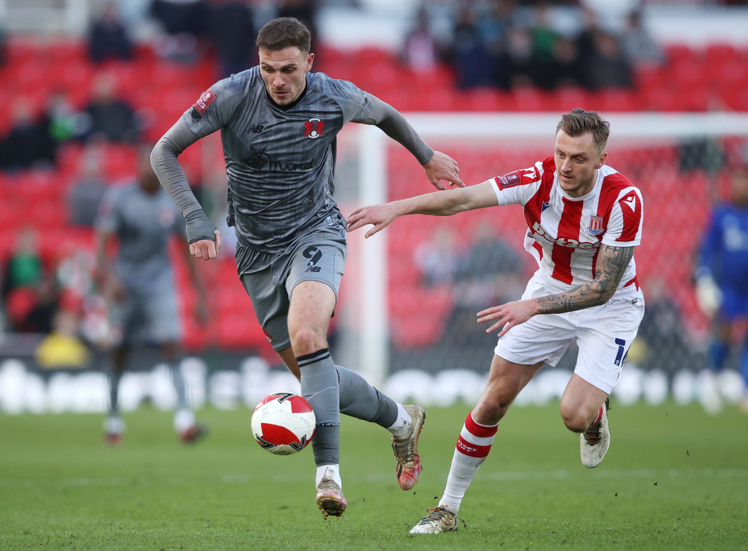 Soccer Football - FA Cup Third Round - Stoke City v Leyton Orient - bet365 Stadium, Stoke-on-Trent, Britain - January 9, 2022 Leyton Orient's Harry Smith in action with Stoke City's Ben Wilmot Action Images via Reuters/Molly Darlington