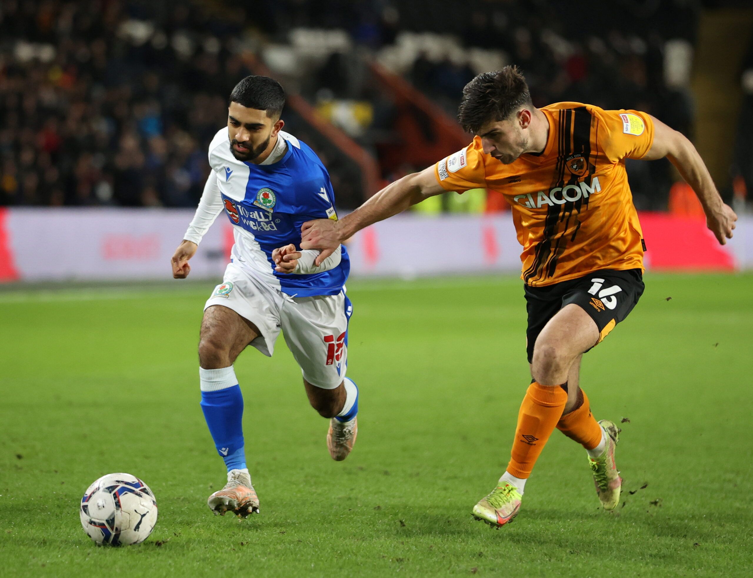 Soccer Football - Championship - Hull City v Blackburn Rovers - KCOM Stadium, Hull, Britain - January 19, 2022  Blackburn Rovers' Dilan Markanday in action with Hull City's Ryan Longman  Action Images/Molly Darlington  EDITORIAL USE ONLY. No use with unauthorized audio, video, data, fixture lists, club/league logos or 