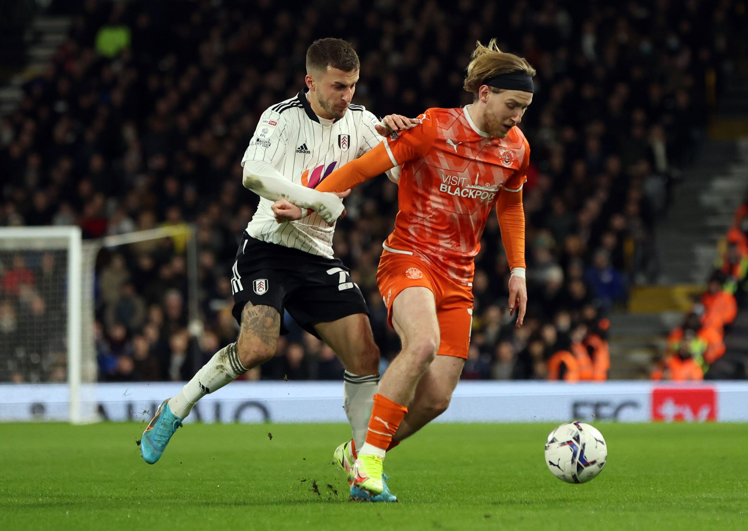 Soccer Football - Championship - Fulham v Blackpool - Craven Cottage, London, Britain - January 29, 2022 Fulham's Joe Bryan in action with Blackpool's Josh Bowler Action Images/Paul Childs EDITORIAL USE ONLY. No use with unauthorized audio, video, data, fixture lists, club/league logos or 'live' services. Online in-match use limited to 75 images, no video emulation. No use in betting, games or single club /league/player publications.  Please contact your account representative for further detail