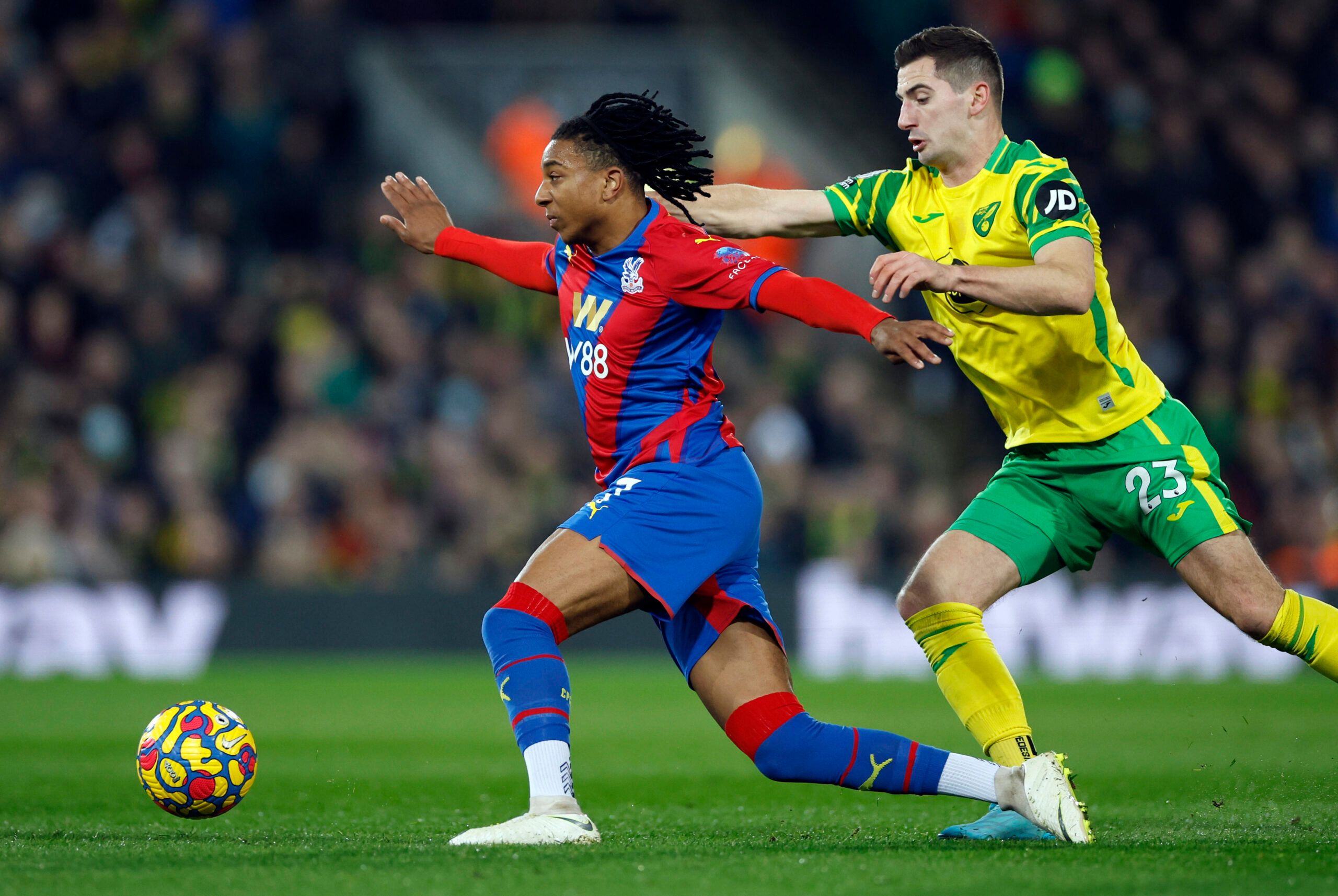 Soccer Football - Premier League - Norwich City v Crystal Palace - Carrow Road, Norwich, Britain - February 9, 2022 Crystal Palace's Michael Olise in action with Norwich City's Kenny McLean Action Images via Reuters/John Sibley EDITORIAL USE ONLY. No use with unauthorized audio, video, data, fixture lists, club/league logos or 'live' services. Online in-match use limited to 75 images, no video emulation. No use in betting, games or single club /league/player publications.  Please contact your ac