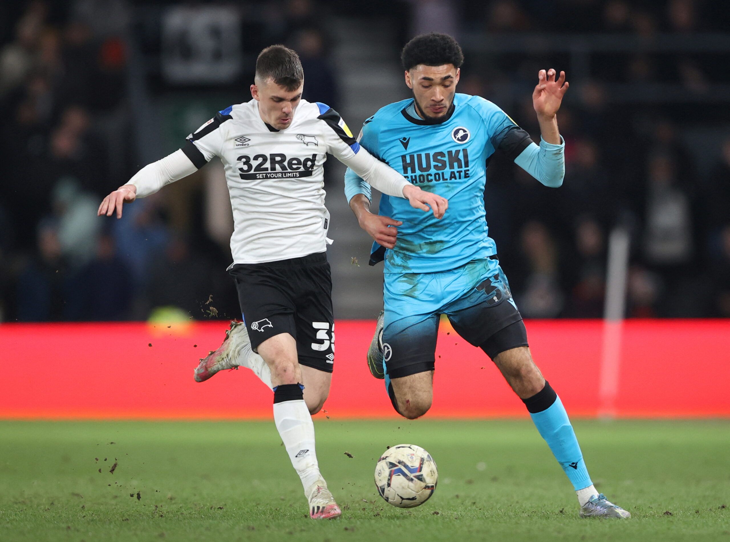 Soccer Football - Championship - Derby County v Millwall - Pride Park, Derby, Britain - February 23, 2022  Derby County's Jason Knight in action with Millwall's Tyler Burey  Action Images/Molly Darlington