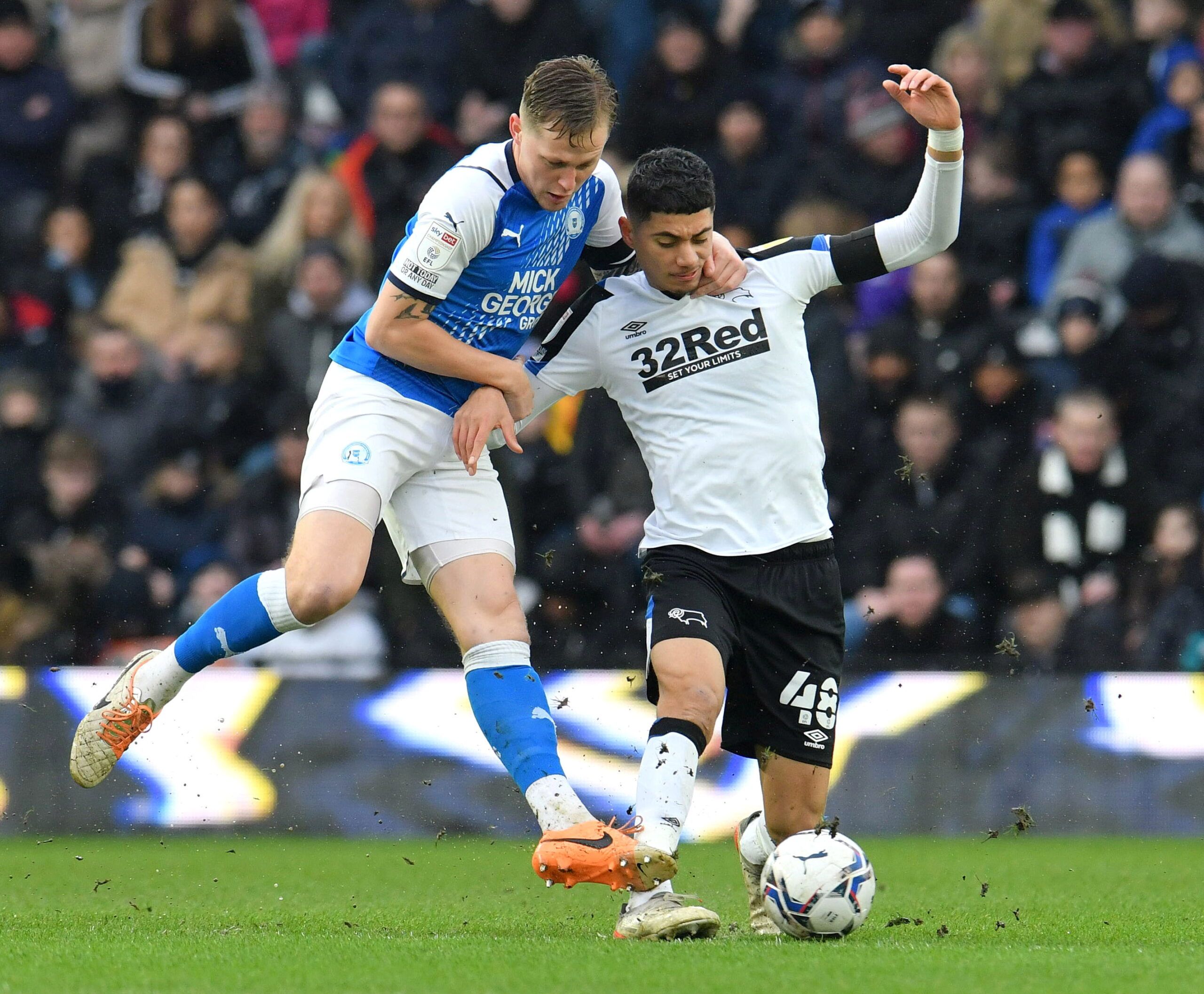 Soccer Football - Championship - Derby County v Peterborough United - Pride Park, Derby, Britain - February 19, 2022 Derby County's Luke Plange in action with Peterborough United's Frankie Kent  Action Images/Paul Burrows??EDITORIAL USE ONLY. No use with unauthorized audio, video, data, fixture lists, club/league logos or 