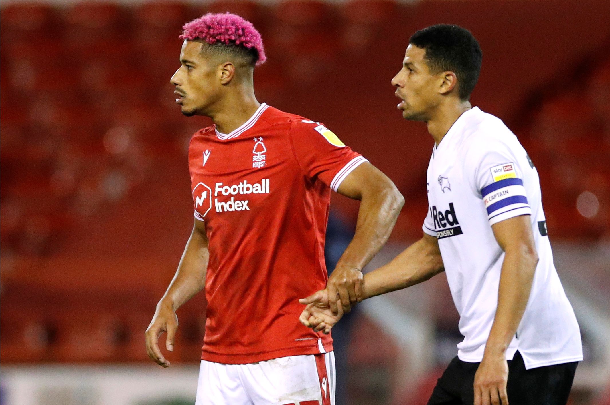 Soccer Football - Championship - Nottingham Forest v Derby County - The City Ground, Nottingham, Britain - October 23, 2020   Nottingham Forest's Lyle Taylor with Derby County's Curtis Davies during the match    Action Images/Andrew Boyers    EDITORIAL USE ONLY. No use with unauthorized audio, video, data, fixture lists, club/league logos or 