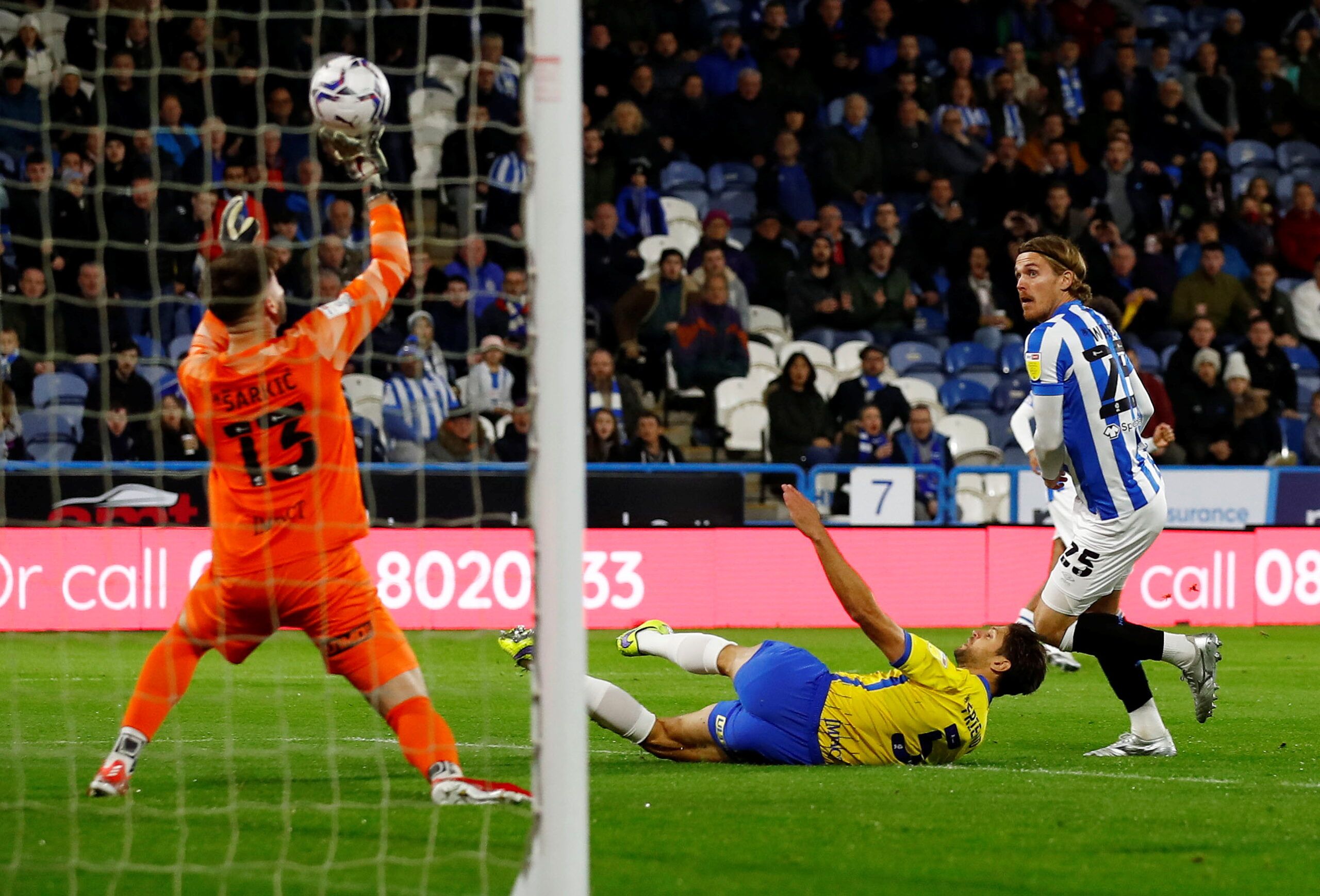 Soccer Football - Championship - Huddersfield Town v Birmingham City - John Smith's Stadium, Huddersfield, Britain - October 20, 2021  Birmingham City's Matija Sarkic makes a save from Huddersfield Town's Danny Ward  Action Images/Jason Cairnduff  EDITORIAL USE ONLY. No use with unauthorized audio, video, data, fixture lists, club/league logos or 