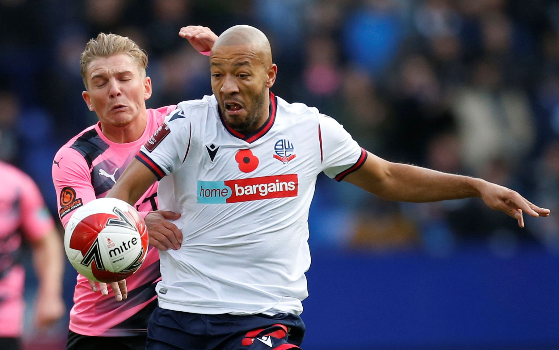 Soccer Football - FA Cup - First Round - Bolton Wanderers v Stockport County - University of Bolton Stadium, Bolton, Britain - November 7, 2021 Bolton Wanderers' Alex Baptiste in action with Stockport County's Ben Whitfield