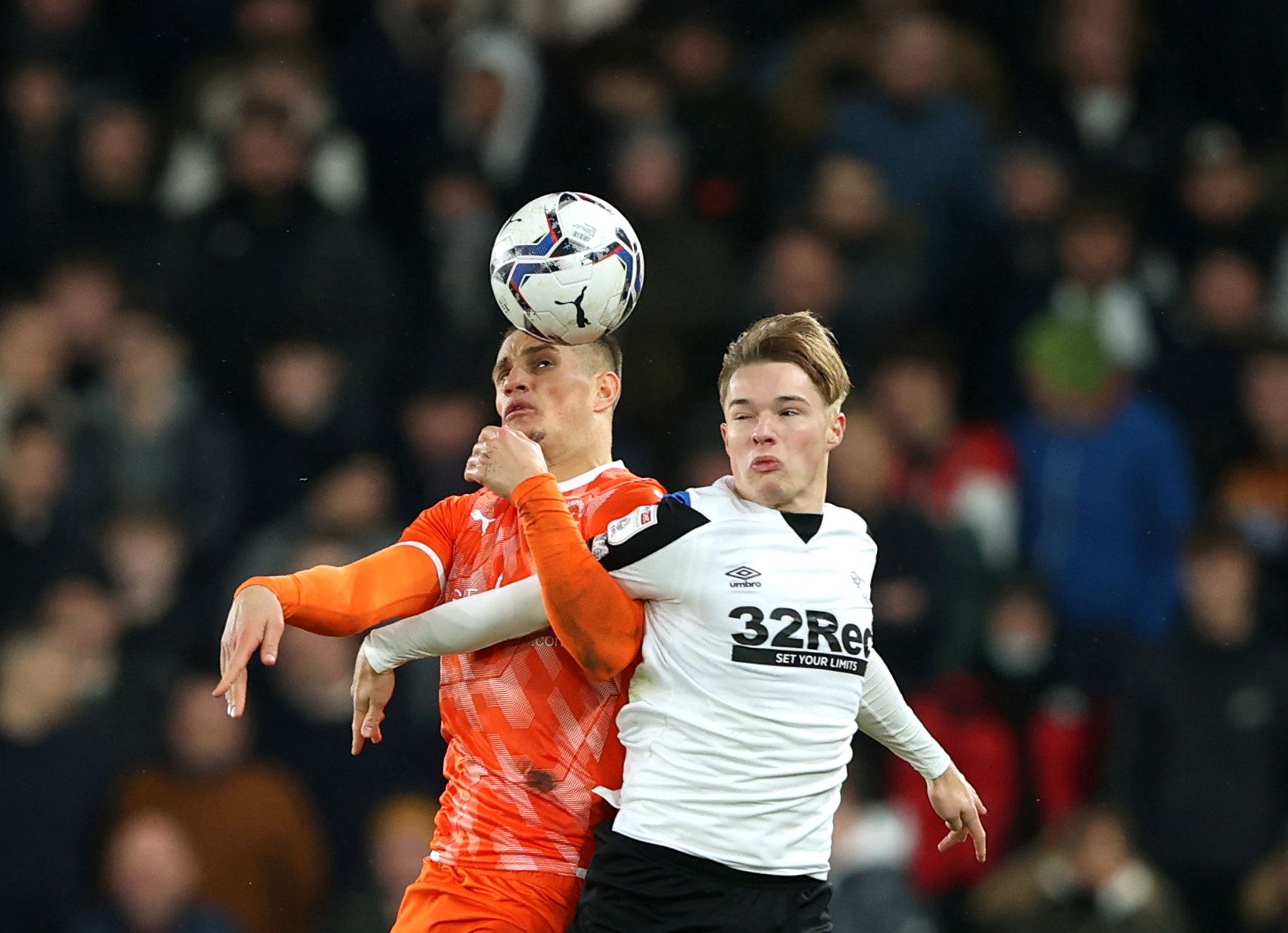 Soccer Football - Championship - Derby County v Blackpool - Pride Park, Derby, Britain - December 11, 2021  Derby County's Liam Thompson in action with Blackpool's Jerry Yates Action Images/Molly Darlington  EDITORIAL USE ONLY. No use with unauthorized audio, video, data, fixture lists, club/league logos or 