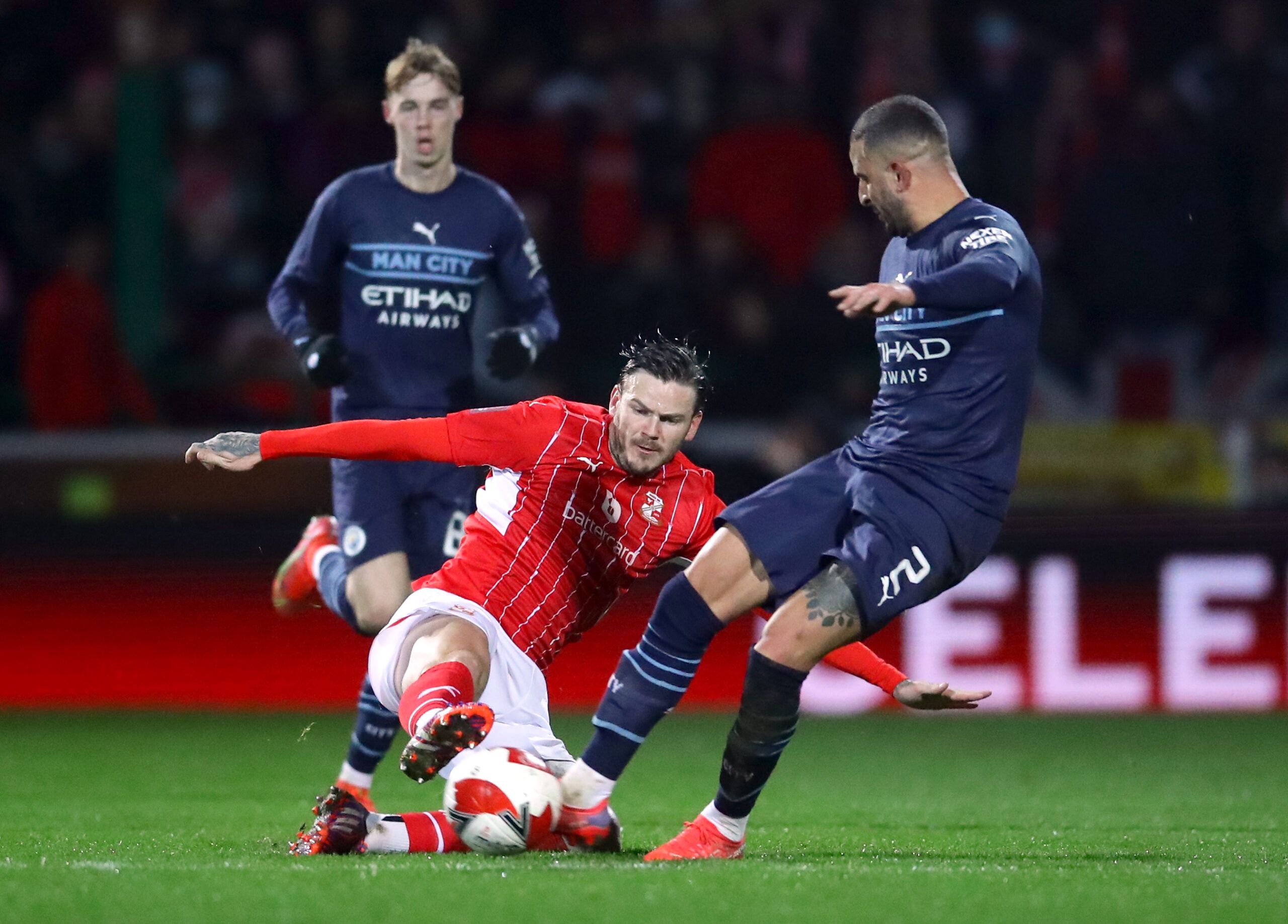 Soccer Football - FA Cup Third Round - Swindon Town v Manchester City - County Ground, Swindon, Britain - January 7, 2022 Swindon Town's Ben Gladwin  in action with Manchester City's Kyle Walker REUTERS/David Klein