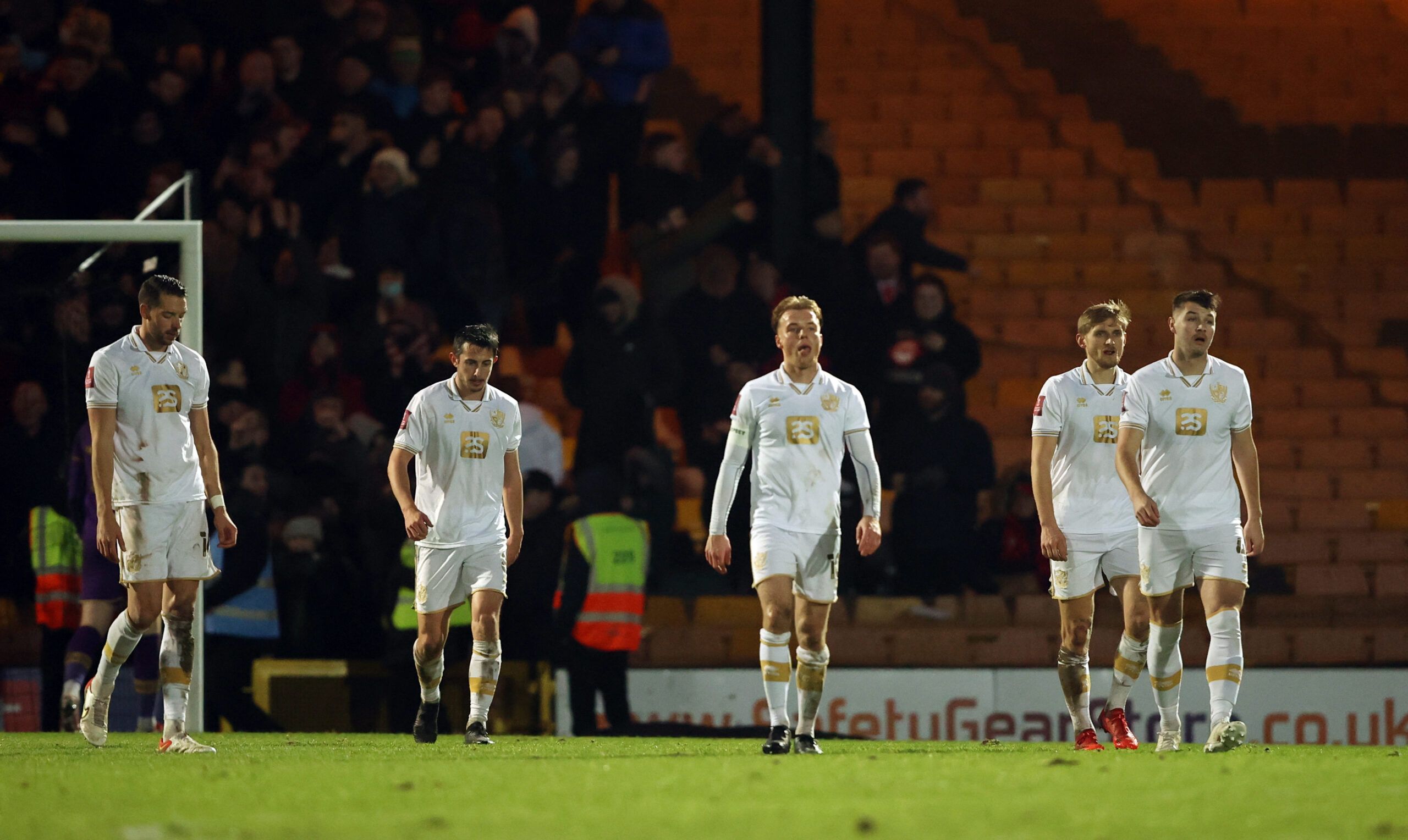 Soccer Football - FA Cup Third Round - Port Vale v Brentford - Vale Park, Stoke-on-Trent, Britain - January 8, 2022  Port Vale's Tom Conlon and teammates look dejected after conceding their fourth goal Action Images via Reuters/Molly Darlington