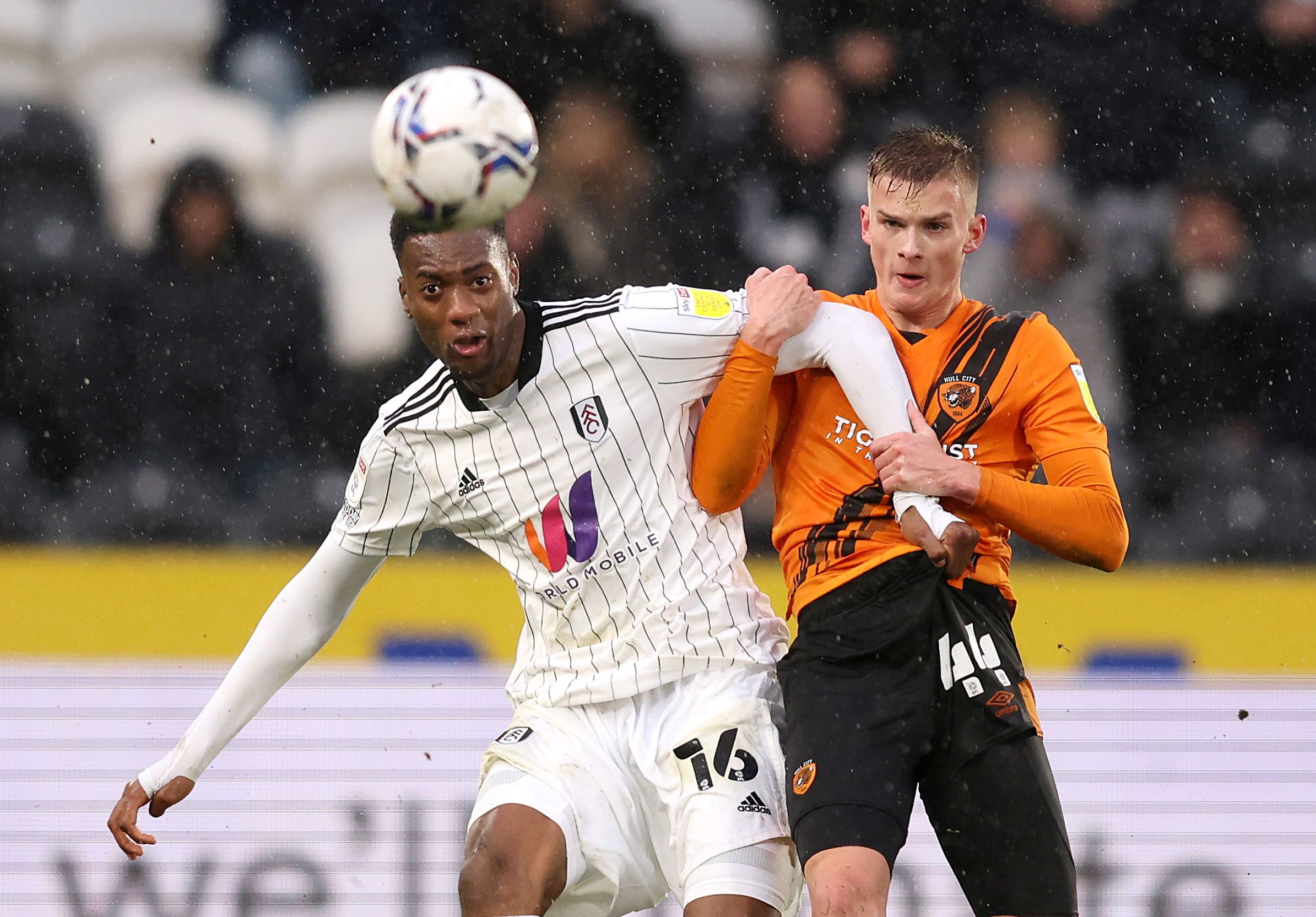 Soccer Football - Championship - Hull City v Fulham - KCOM Stadium, Hull, Britain - February 12, 2022  Fulham's Tosin Adarabioyo in action with Hull City's Marcus Forss  Action Images/John Clifton  EDITORIAL USE ONLY. No use with unauthorized audio, video, data, fixture lists, club/league logos or "live" services. Online in-match use limited to 75 images, no video emulation. No use in betting, games or single club/league/player publications.  Please contact your account representative for furthe
