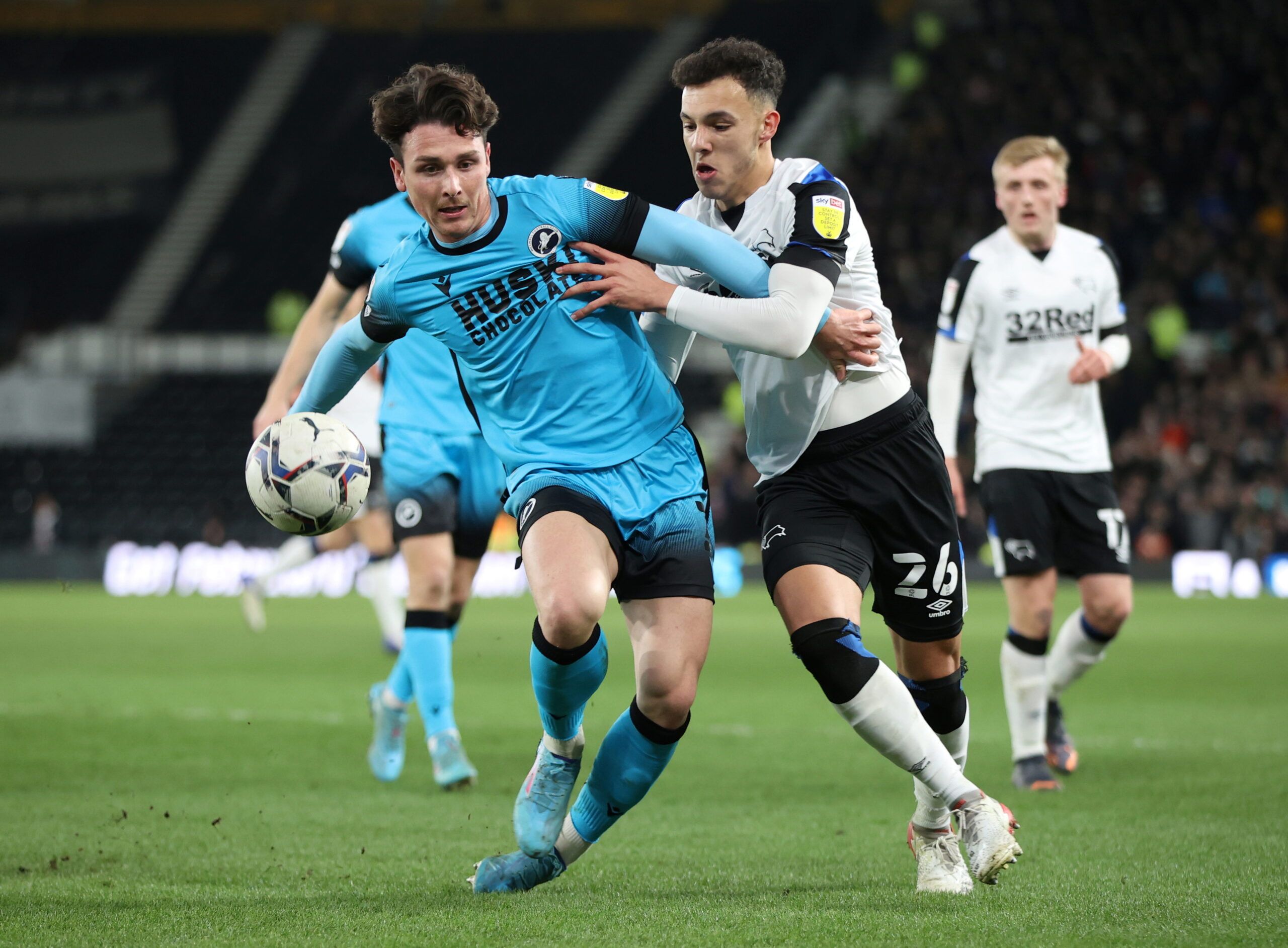 Soccer Football - Championship - Derby County v Millwall - Pride Park, Derby, Britain - February 23, 2022  Millwall's Danny McNamara in action with Derby County's Lee Buchanan Action Images/Molly Darlington