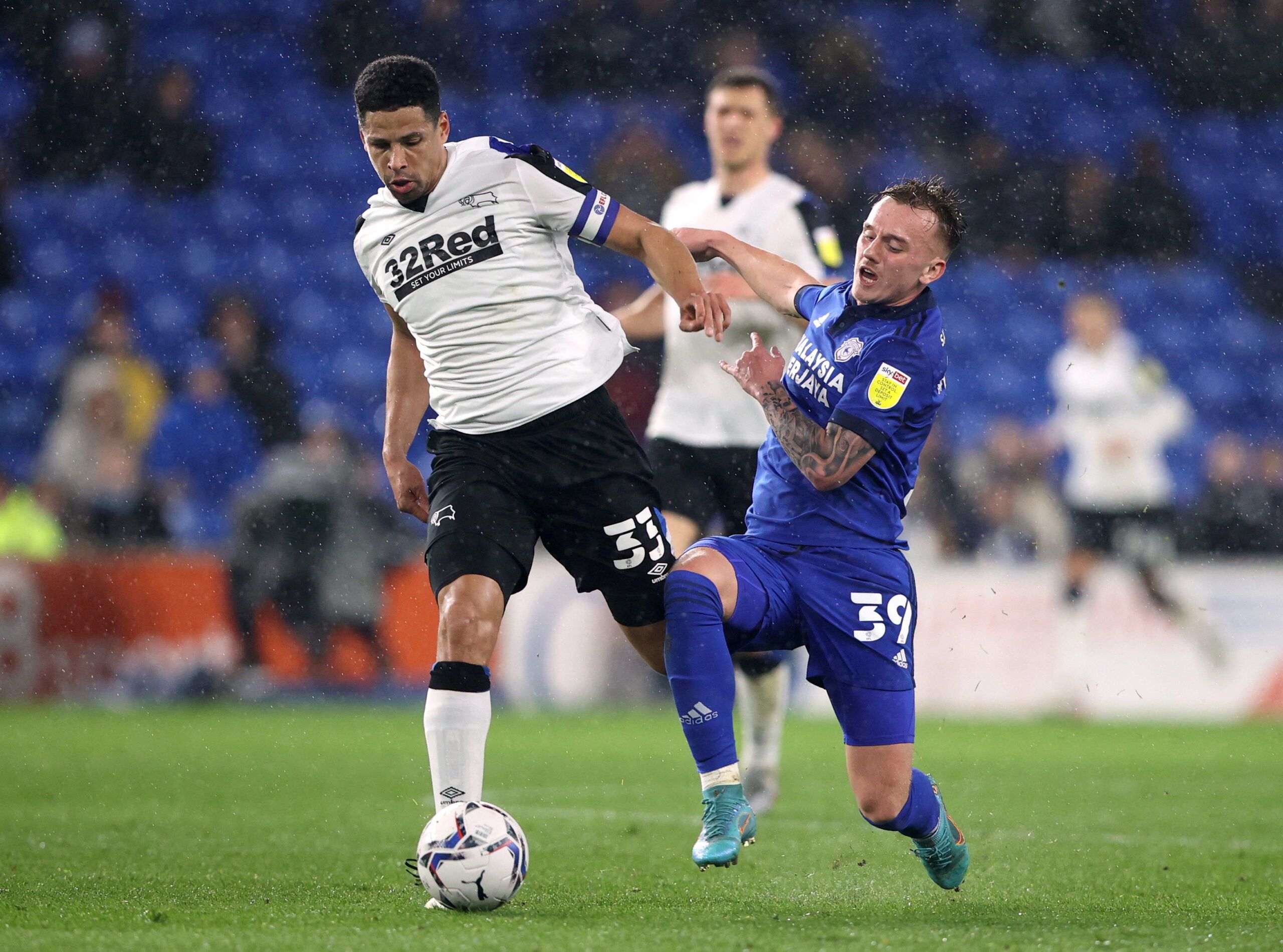 Soccer Football - Championship - Cardiff City v Derby County - Cardiff City Stadium, Cardiff, Britain - March 1, 2022   Derby County's Curtis Davies in action with Cardiff City's Isaac Davies   Action Images/Molly Darlington    EDITORIAL USE ONLY. No use with unauthorized audio, video, data, fixture lists, club/league logos or 