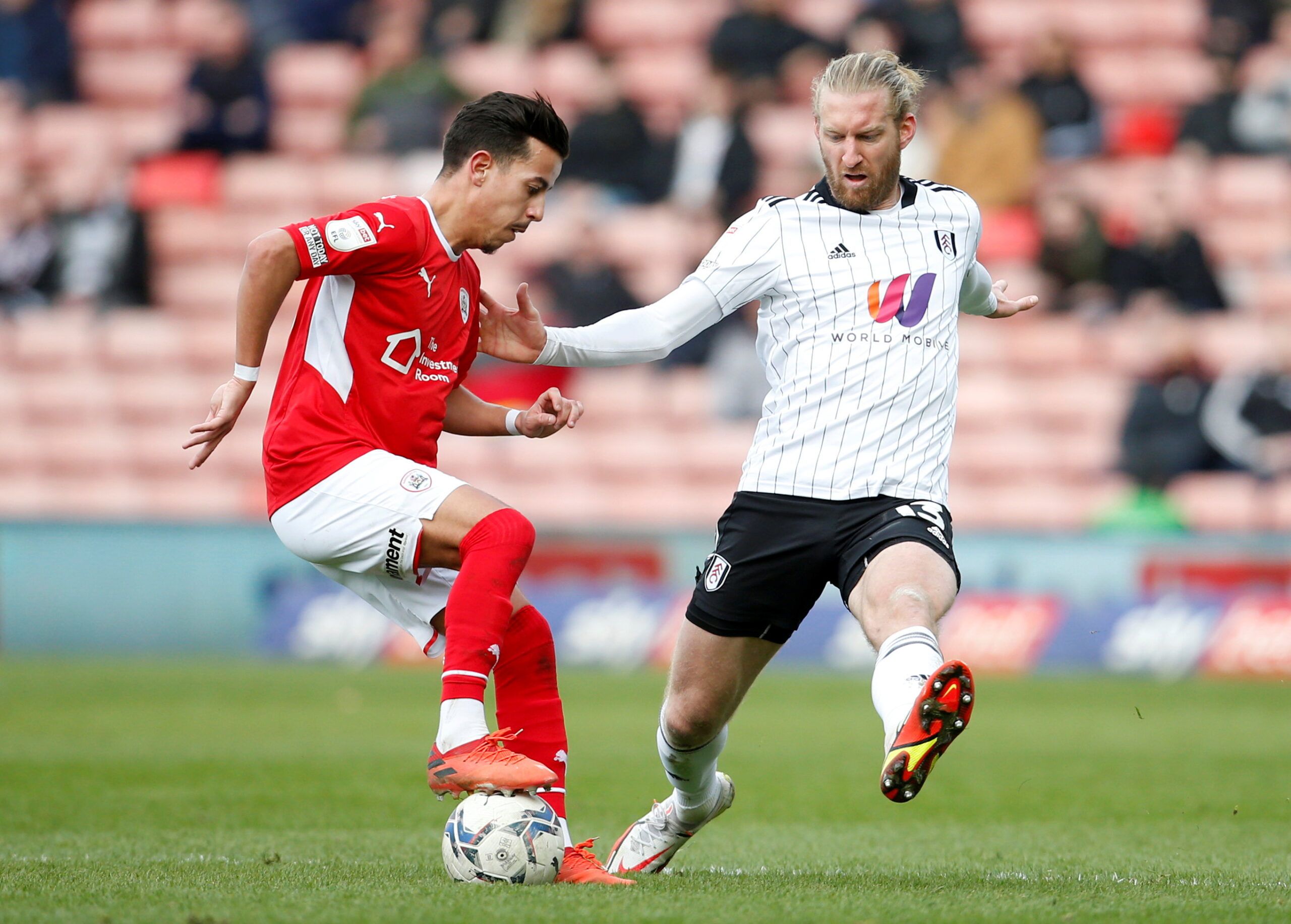 Soccer Football - Championship - Barnsley v Fulham - Oakwell, Barnsley, Britain - March 12, 2022   Barnsley's Amine Bassi and Fulham's Tim Ream in action  Action Images/Ed Sykes  EDITORIAL USE ONLY. No use with unauthorized audio, video, data, fixture lists, club/league logos or 