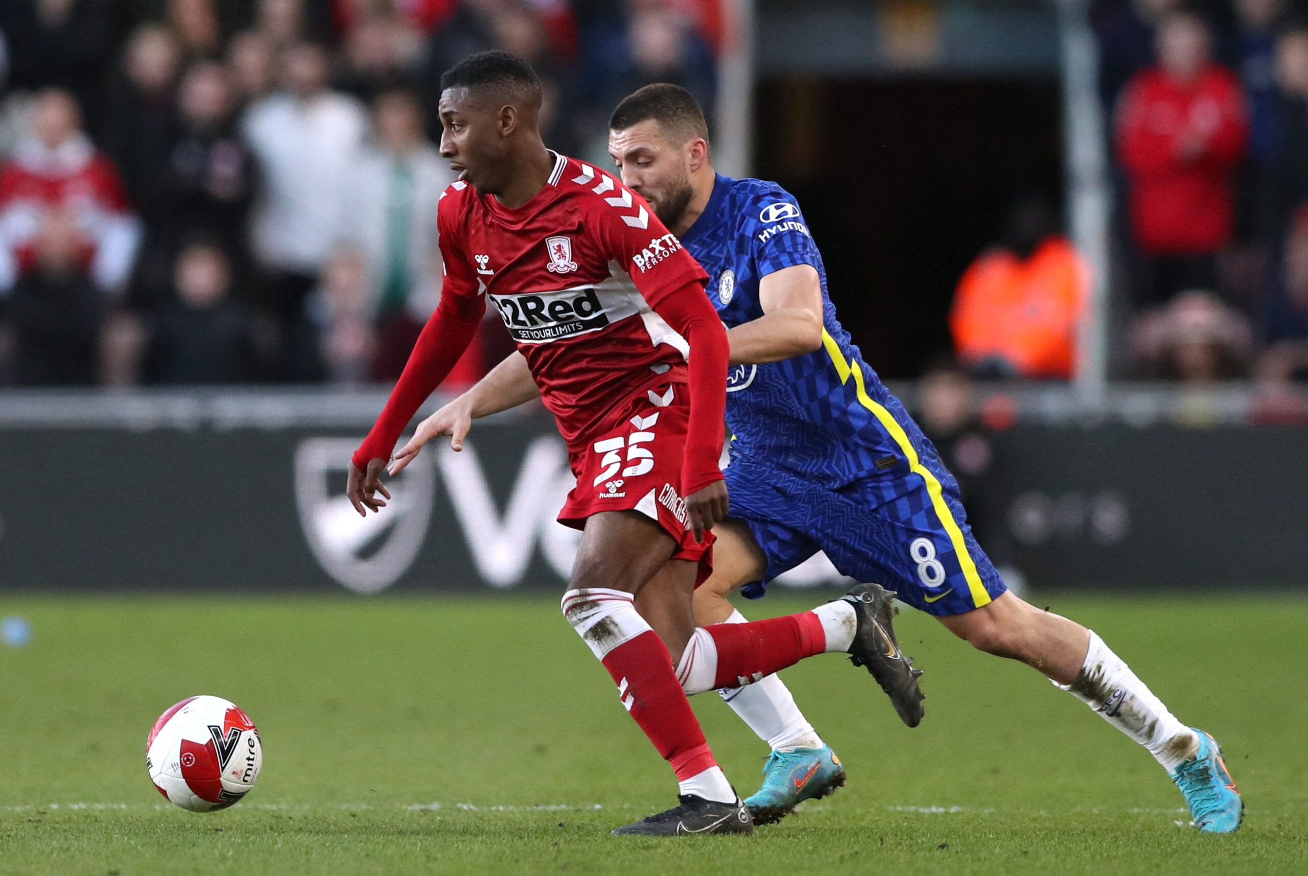 Soccer Football - FA Cup Quarter Final - Middlesbrough v Chelsea - Riverside Stadium, Middlesbrough, Britain - March 19, 2022 Middlesbrough's Isaiah Jones in action with Chelsea's Mateo Kovacic REUTERS/Scott Heppell