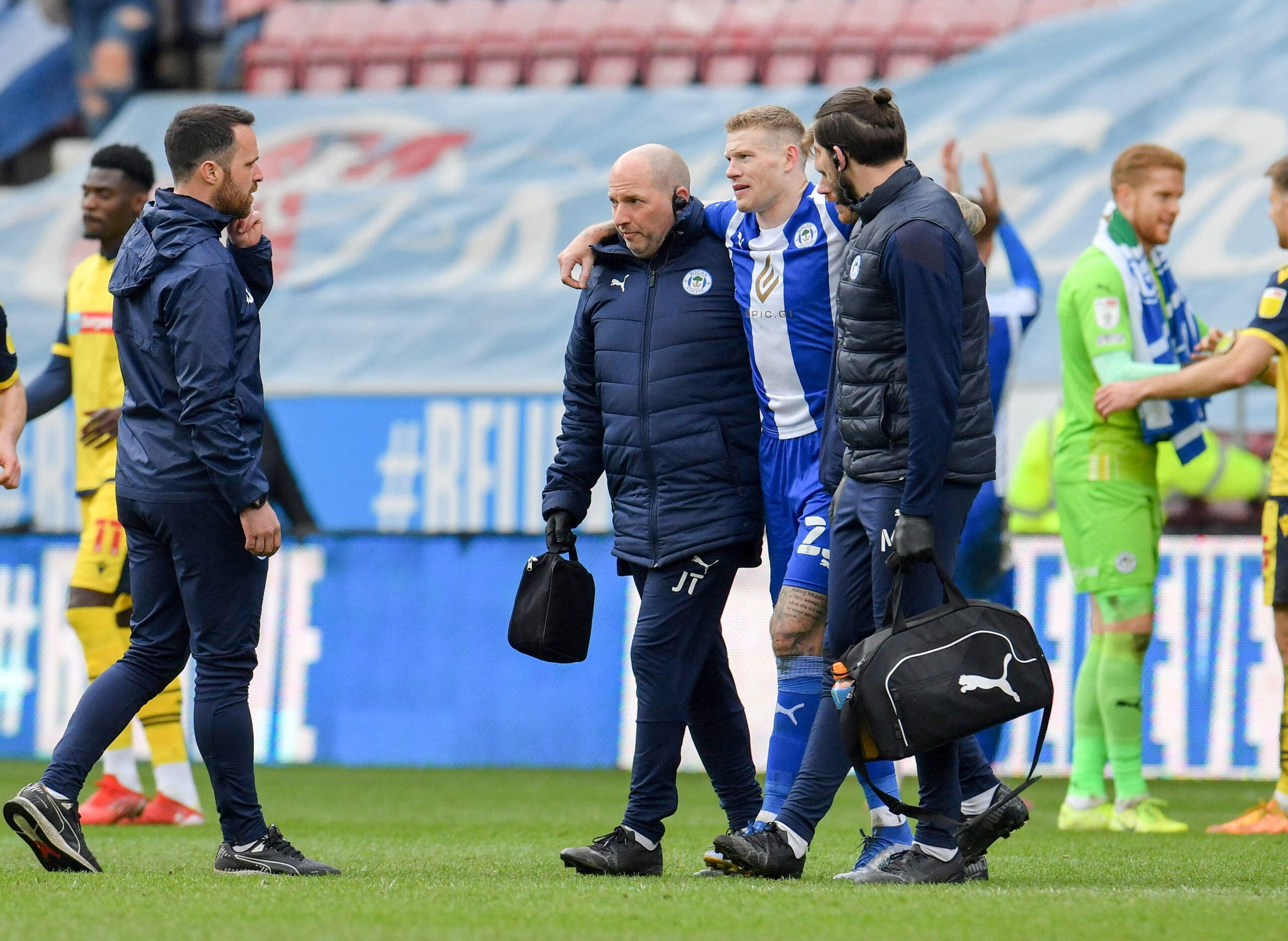 Soccer Football - League One - Wigan Athletic v Bolton Wanderers - DW Stadium, Wigan, Britain - April 2, 2022 gan Athletic's James McClean is helped off the pitch at full time  Action Images/Paul Burrows  EDITORIAL USE ONLY. No use with unauthorized audio, video, data, fixture lists, club/league logos or 