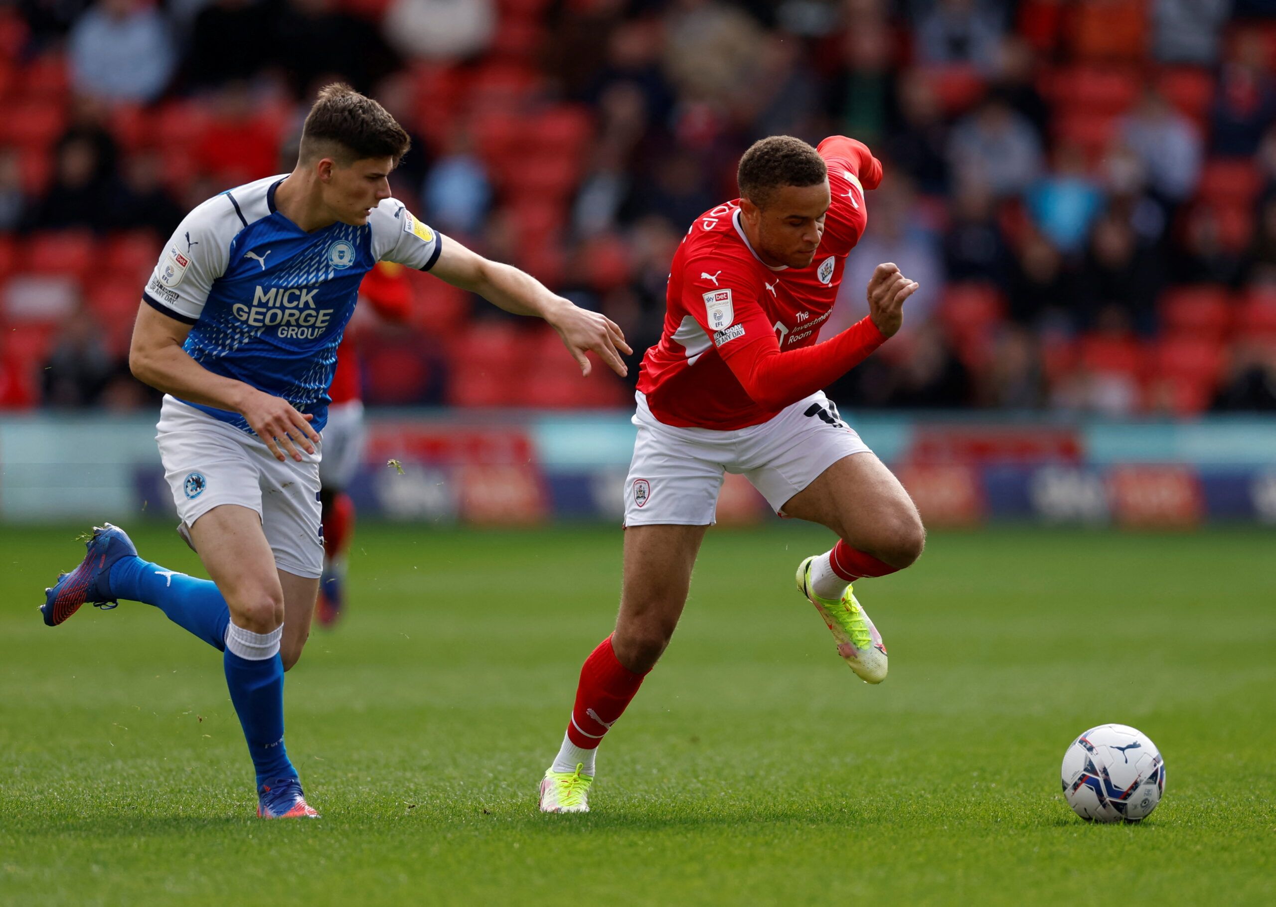 Soccer Football - Championship - Barnsley v Peterborough United - Oakwell, Barnsley, Britain - April 18, 2022 Peterborough United's Ronnie Edwards in action with Barnsley's Carlton Morris  Action Images/Jason Cairnduff  EDITORIAL USE ONLY. No use with unauthorized audio, video, data, fixture lists, club/league logos or 