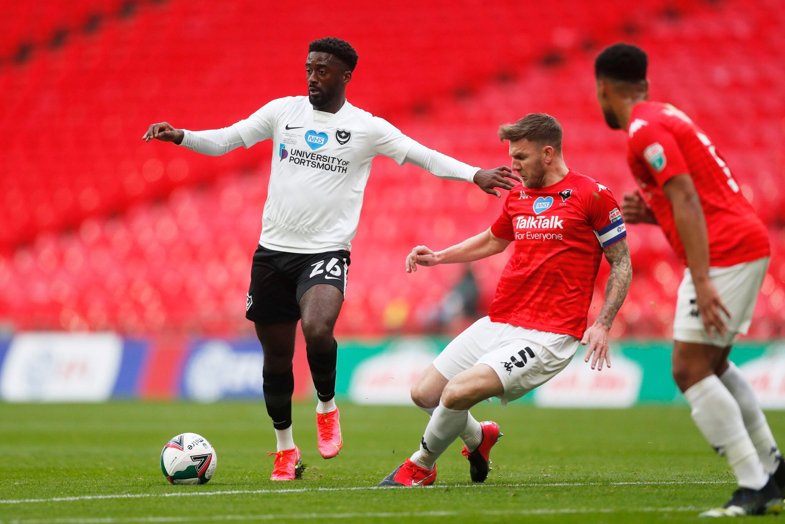 Soccer Football - 2019/20 EFL Trophy Final - Portsmouth v Salford City - Wembley Stadium, London, Britain - March 13, 2021 Salford's Ashley Eastham in action with Portsmouth's Jordy Hiwula Action Images/Matthew Childs EDITORIAL USE ONLY. No use with unauthorized audio, video, data, fixture lists, club/league logos or 'live' services. Online in-match use limited to 75 images, no video emulation. No use in betting, games or single club /league/player publications.  Please contact your account repr