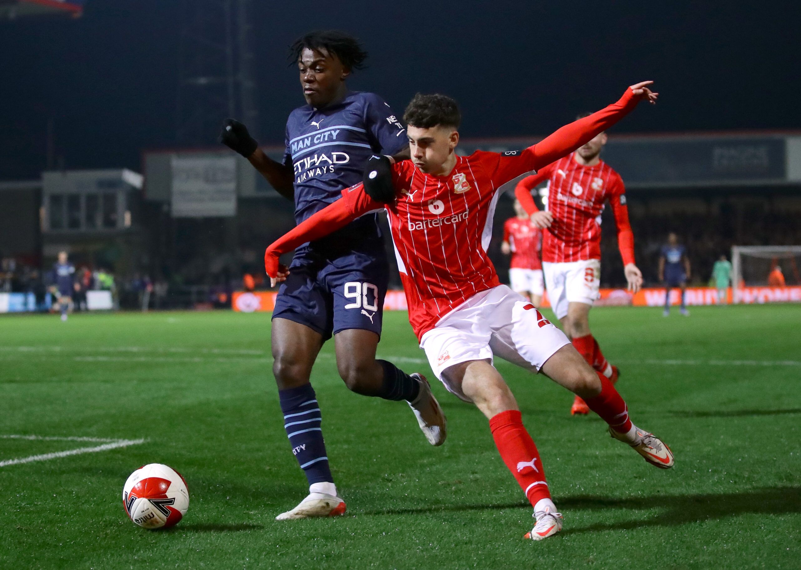 Soccer Football - FA Cup Third Round - Swindon Town v Manchester City - County Ground, Swindon, Britain - January 7, 2022 Manchester City's Romeo Lavia in action with Swindon Town's Ryan East REUTERS/David Klein