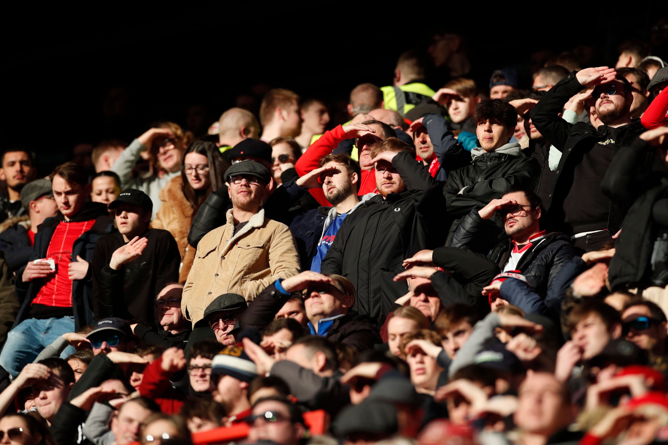 Soccer Football - FA Cup Third Round - Charlton Athletic v Norwich City - The Valley, London, Britain - January 9, 2022 Charlton Athletic fans shield their eyes from the sun during the match Action Images via Reuters/Peter Cziborra