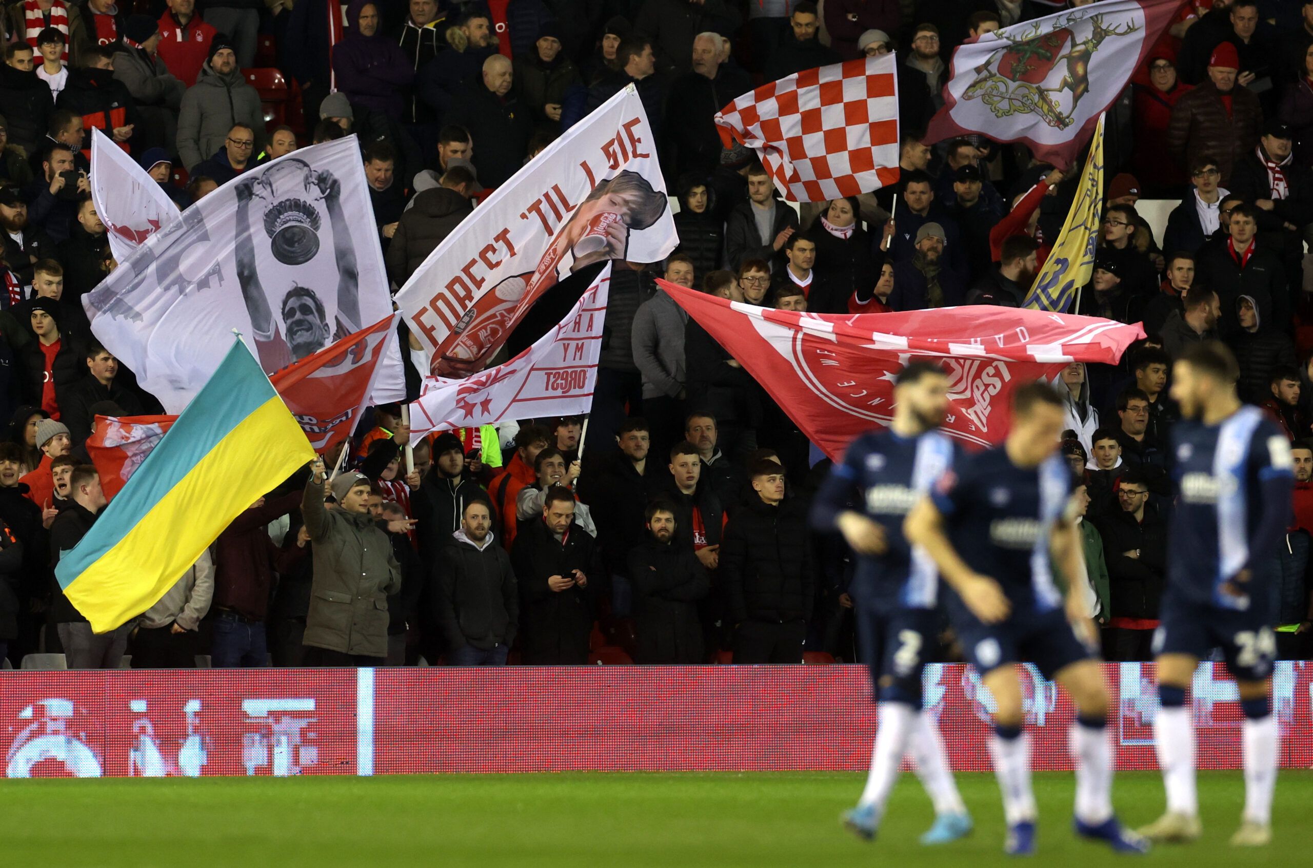 Soccer Football - FA Cup Fifth Round - Nottingham Forest v Huddersfield Town - The City Ground, Nottingham, Britain - March 7, 2022 Nottingham Forest fan with a flag in support of Ukraine amid Russia's invasion before the match Action Images via Reuters/Paul Childs