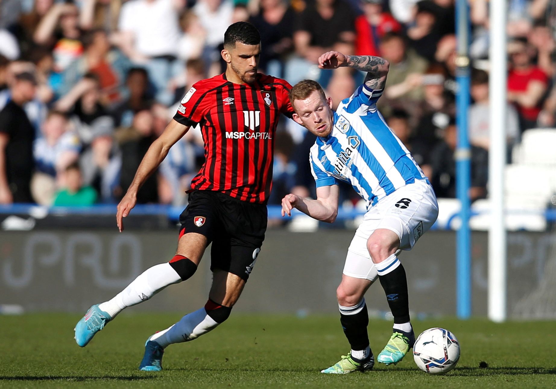 Soccer Football - Championship - Huddersfield Town v AFC Bournemouth - John Smith's Stadium, Huddersfield, Britain - March 19, 2022 AFC Bournemouth's Dominic Solanke in action with Huddersfield Town's Lewis O'Brien  Action Images/Ed Sykes  EDITORIAL USE ONLY. No use with unauthorized audio, video, data, fixture lists, club/league logos or 
