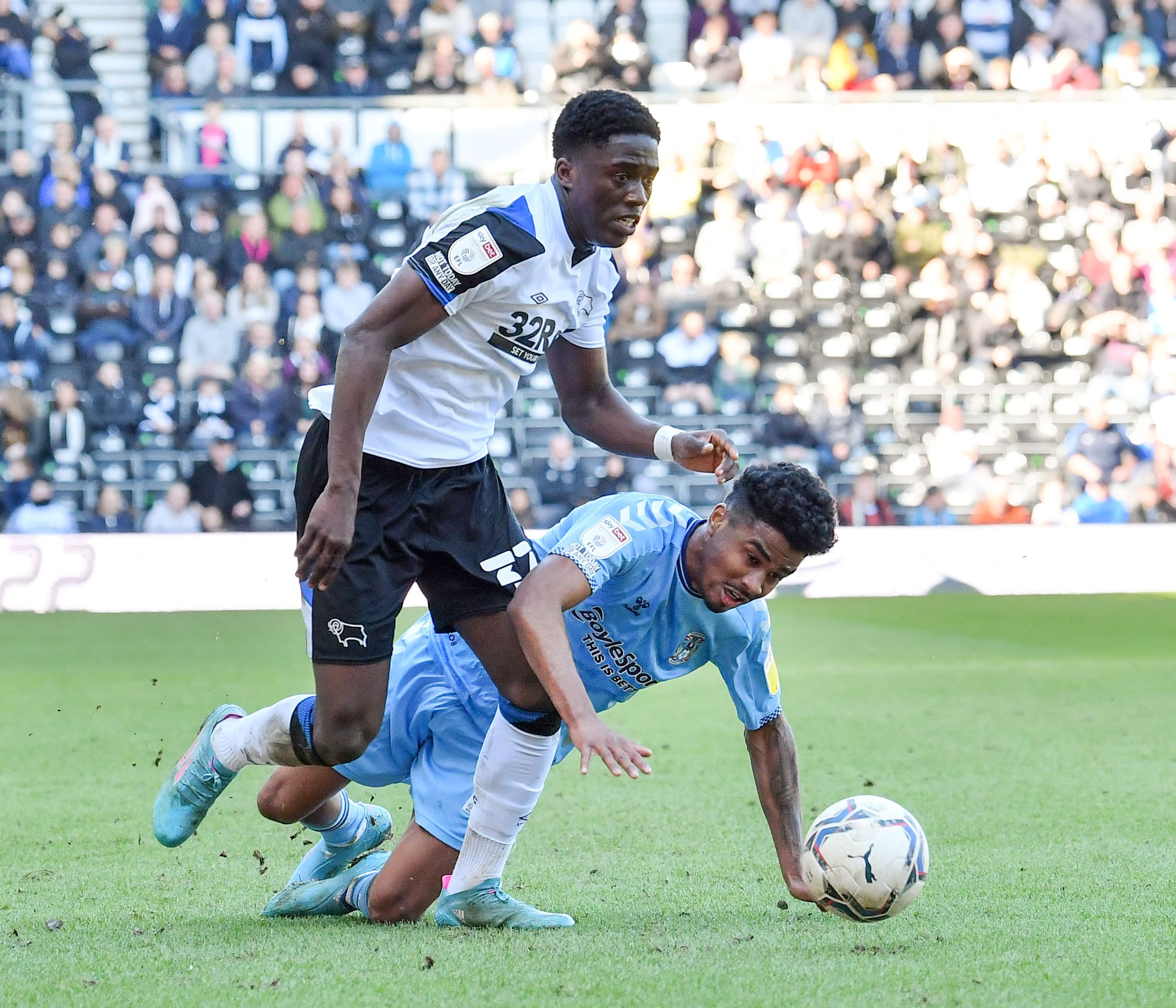 Soccer Football - Championship - Derby County v Coventry City - Pride Park, Derby, Britain - March 19, 2022 Derby County's Malcolm Ebiowei in action with Coventry City's Ian Maatsen Action Images/Paul Burrows  EDITORIAL USE ONLY. No use with unauthorized audio, video, data, fixture lists, club/league logos or 