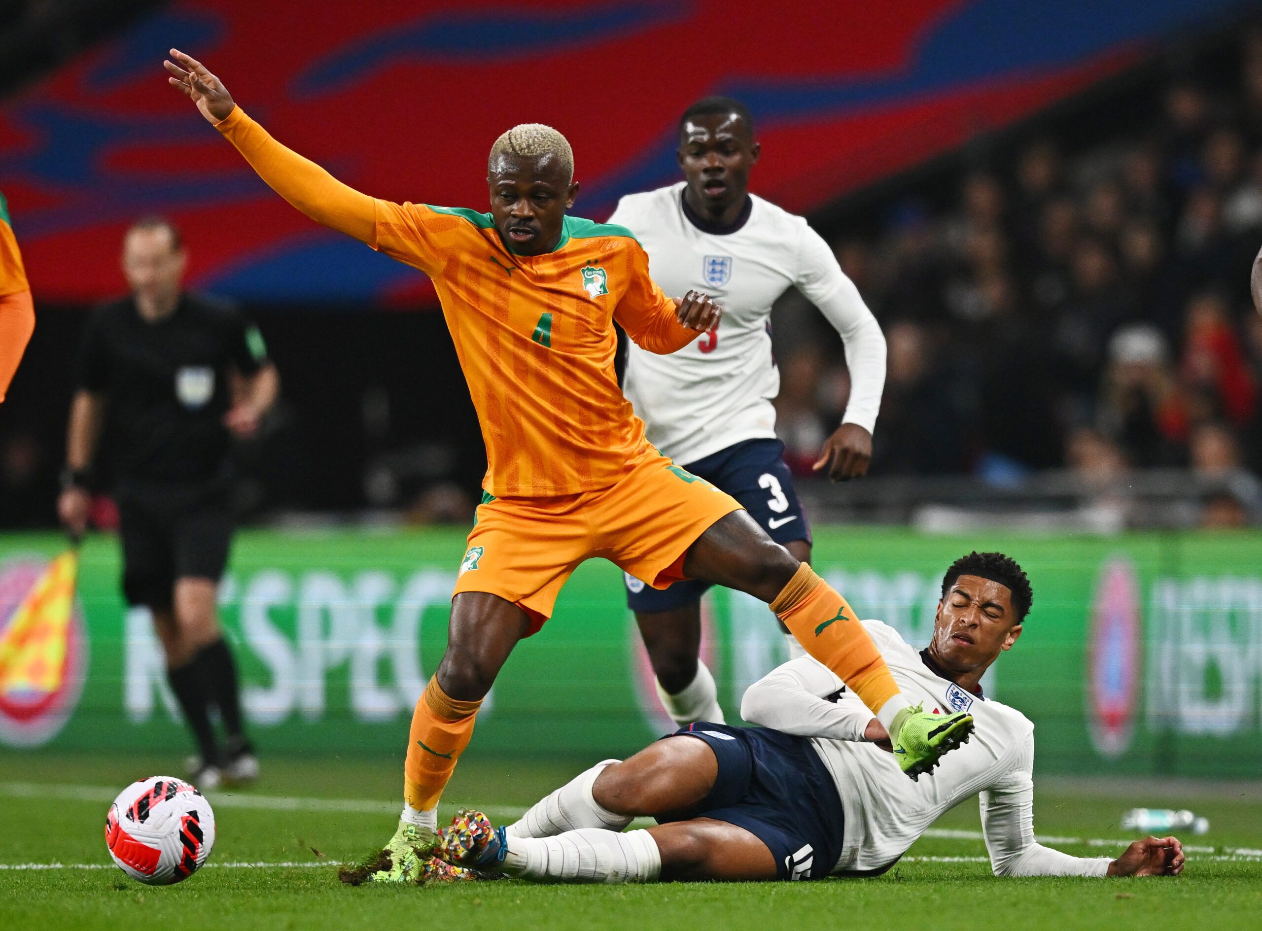Soccer Football - International Friendly - England v Ivory Coast - Wembley Stadium, London, Britain - March 29, 2022 Ivory Coast's Jean Michael Seri in action with England's Jude Bellingham REUTERS/Dylan Martinez