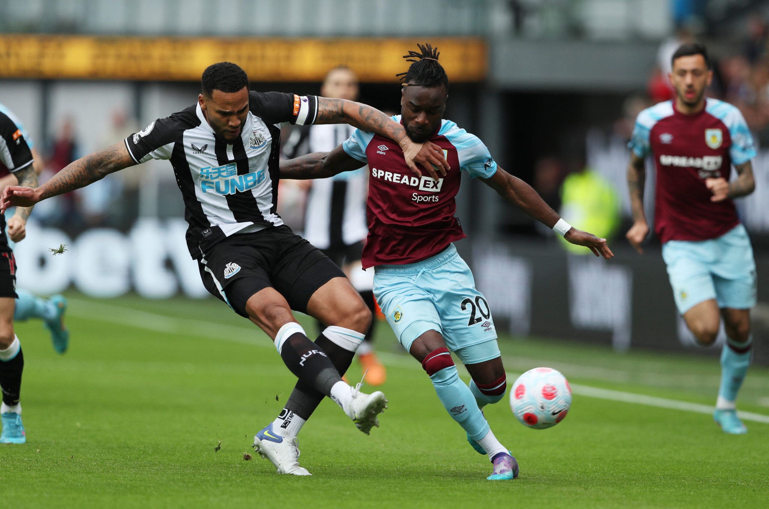 Soccer Football - Premier League - Burnley v Newcastle United - Turf Moor, Burnley, Britain - May 22, 2022 Newcastle United's Jamaal Lascelles in action with Burnley's Maxwel Cornet REUTERS/Scott Heppell EDITORIAL USE ONLY. No use with unauthorized audio, video, data, fixture lists, club/league logos or 'live' services. Online in-match use limited to 75 images, no video emulation. No use in betting, games or single club /league/player publications.  Please contact your account representative for