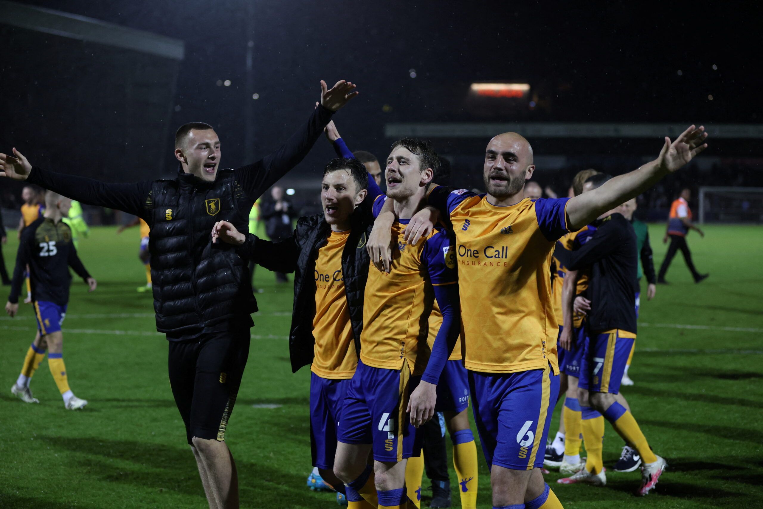 Soccer Football - League Two - Play-Off Semi Final Second Leg - Northampton Town v Mansfield Town - Sixfields Stadium, Northampton, Britain - May 18, 2022   Mansfield's Elliott Hewitt, Farrend Rawson and teammates celebrate after the match   Action Images/Paul Childs    EDITORIAL USE ONLY. No use with unauthorized audio, video, data, fixture lists, club/league logos or 