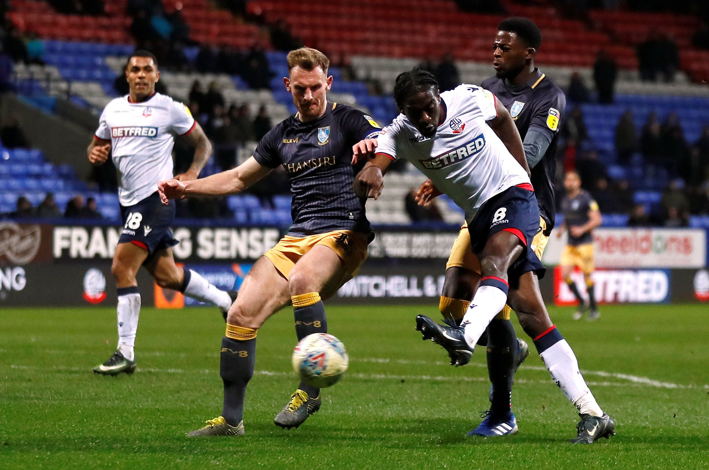 Soccer Football - Championship - Bolton Wanderers v Sheffield Wednesday - University of Bolton Stadium, Bolton, Britain - March 12, 2019   Sheffield Wednesday's Tom Lees in action with Bolton Wanderers' Clayton Donaldson   Action Images/Jason Cairnduff    EDITORIAL USE ONLY. No use with unauthorized audio, video, data, fixture lists, club/league logos or 