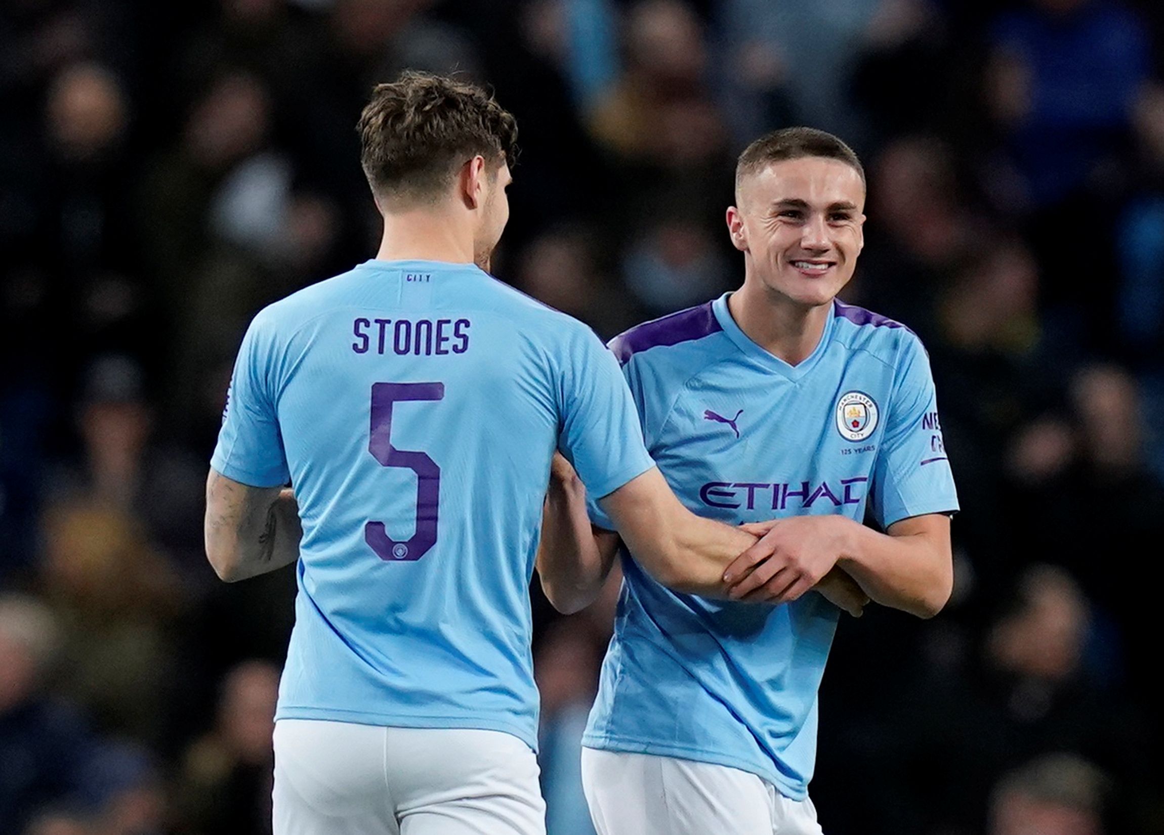 Soccer Football - FA Cup - Third Round - Manchester City v Port Vale - Etihad Stadium, Manchester, Britain - January 4, 2020  Manchester City's Taylor Harwood-Bellis celebrates scoring their third goal with John Stones   REUTERS/Andrew Yates