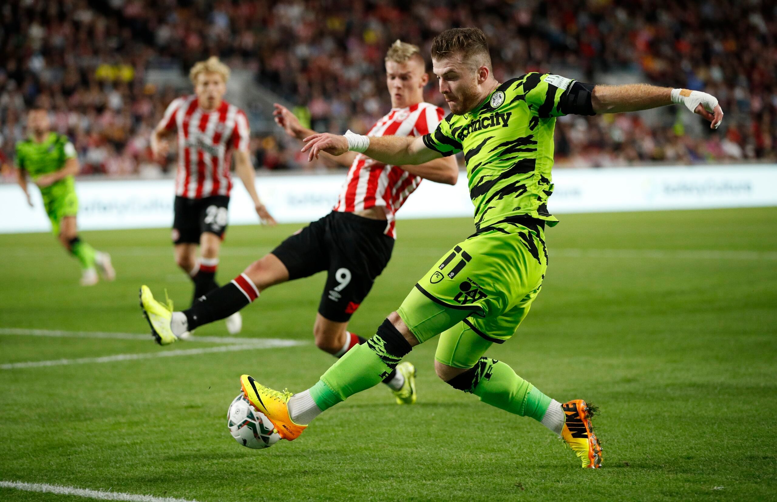 Soccer - England - Carabao Cup Second Round - Brentford v Forest Green Rovers - Community Stadium, London, Britain - August 24, 2021  Forest Green Rovers' Nicky Cadden in action with Brentford's Marcus Forss Action Images via Reuters/John Sibley