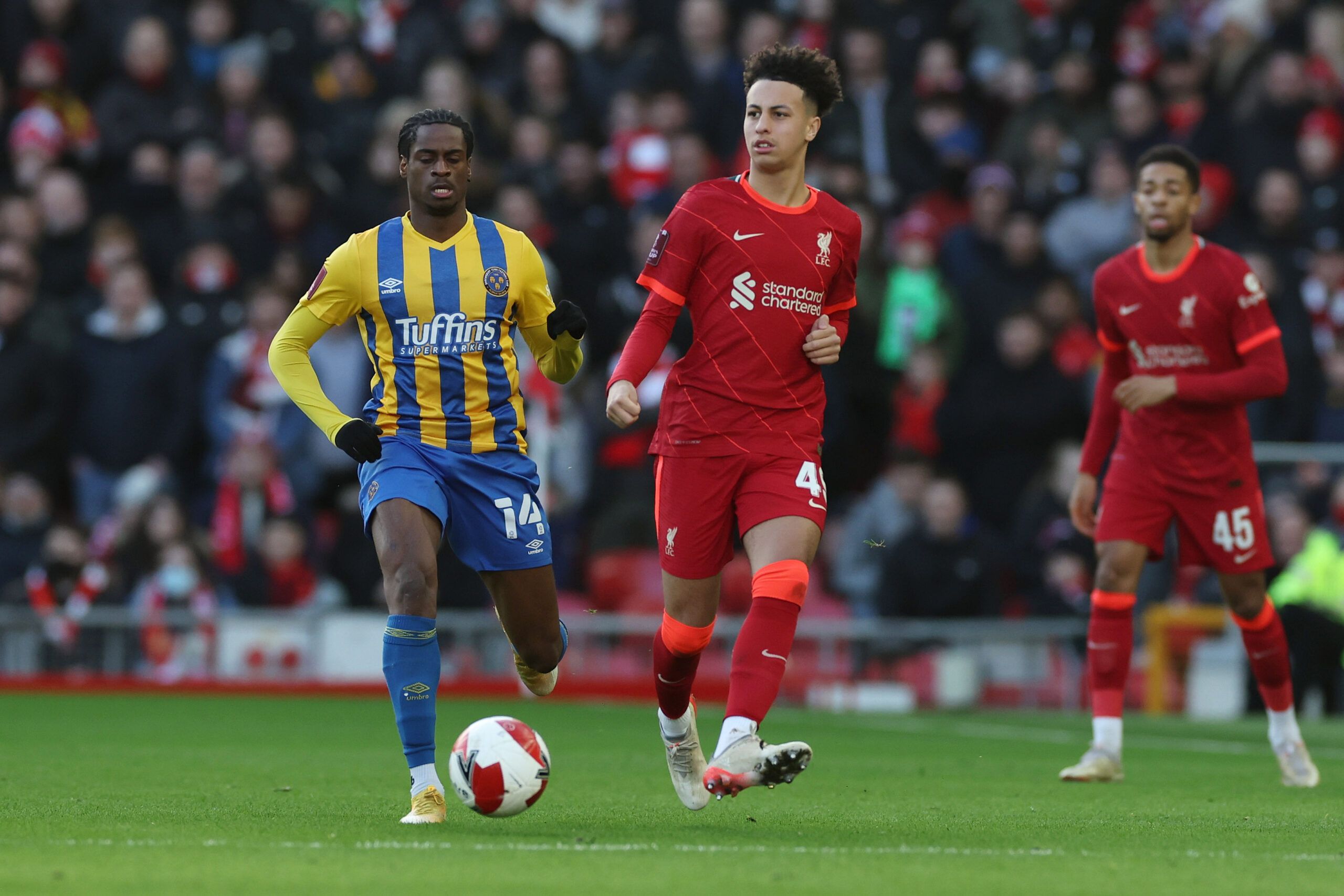 Soccer Football - FA Cup Third Round - Liverpool v Shrewsbury Town - Anfield, Liverpool, Britain - January 9, 2022 Shrewsbury Town's Nathanael Ogbeta in action with Liverpool's Kaide Gordon REUTERS/Phil Noble