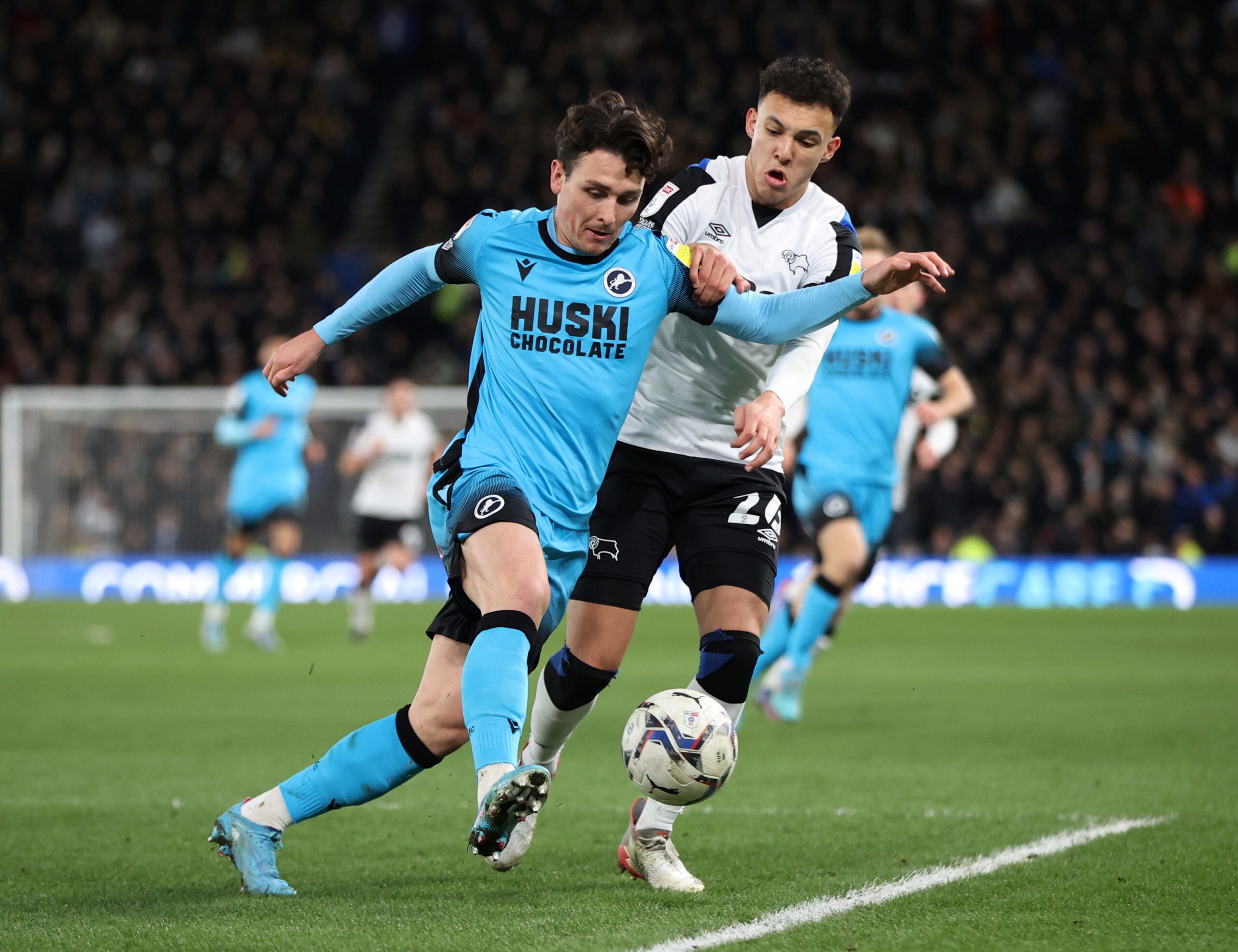 Soccer Football - Championship - Derby County v Millwall - Pride Park, Derby, Britain - February 23, 2022  Millwall's Danny McNamara in action with Derby County's Lee Buchanan Action Images/Molly Darlington