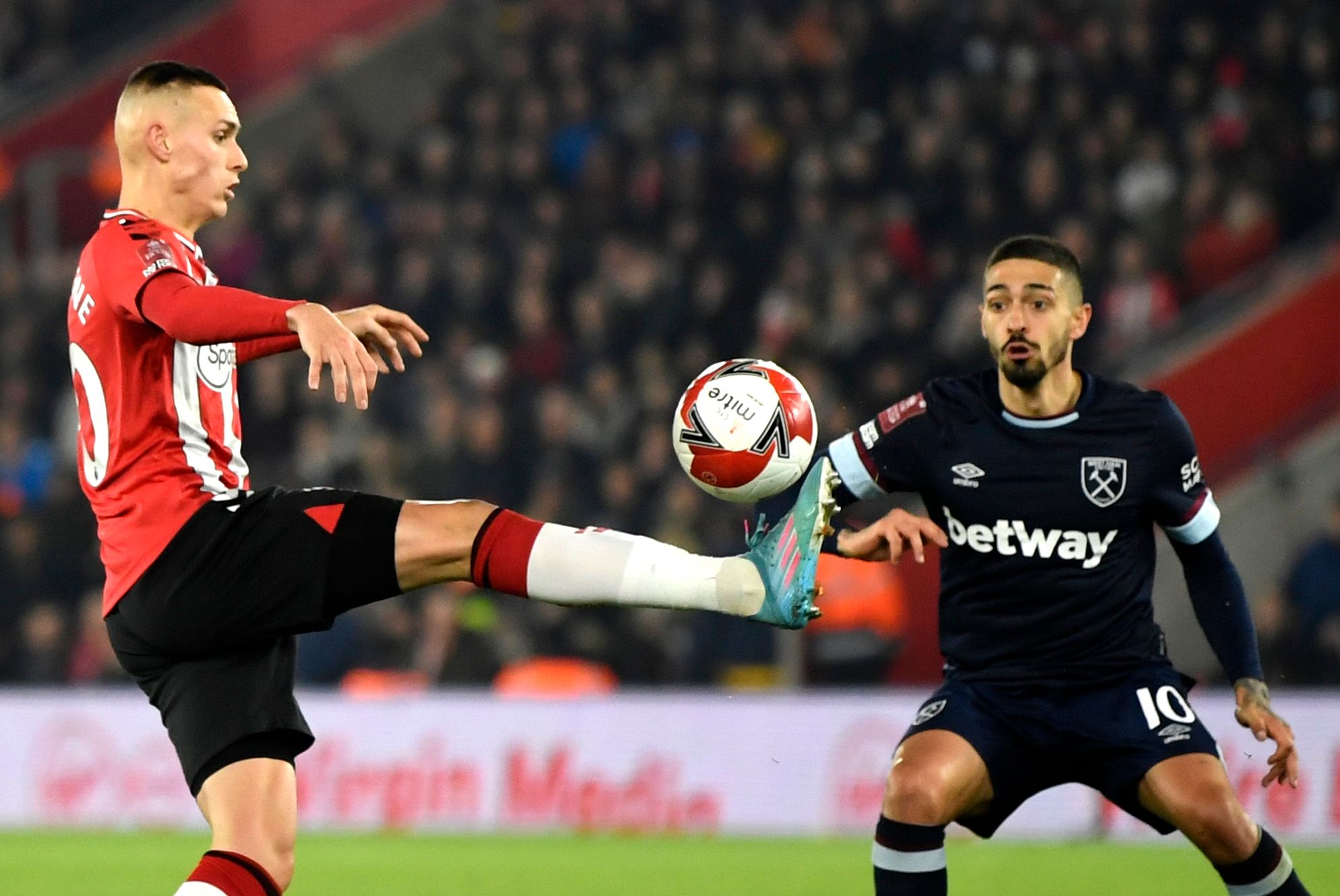 Soccer Football - FA Cup Fifth Round - Southampton v West Ham United - St Mary's Stadium, Southampton, Britain - March 2, 2022 Southampton's Will Smallbone in action with West Ham United's Manuel Lanzini REUTERS/Tony Obrien