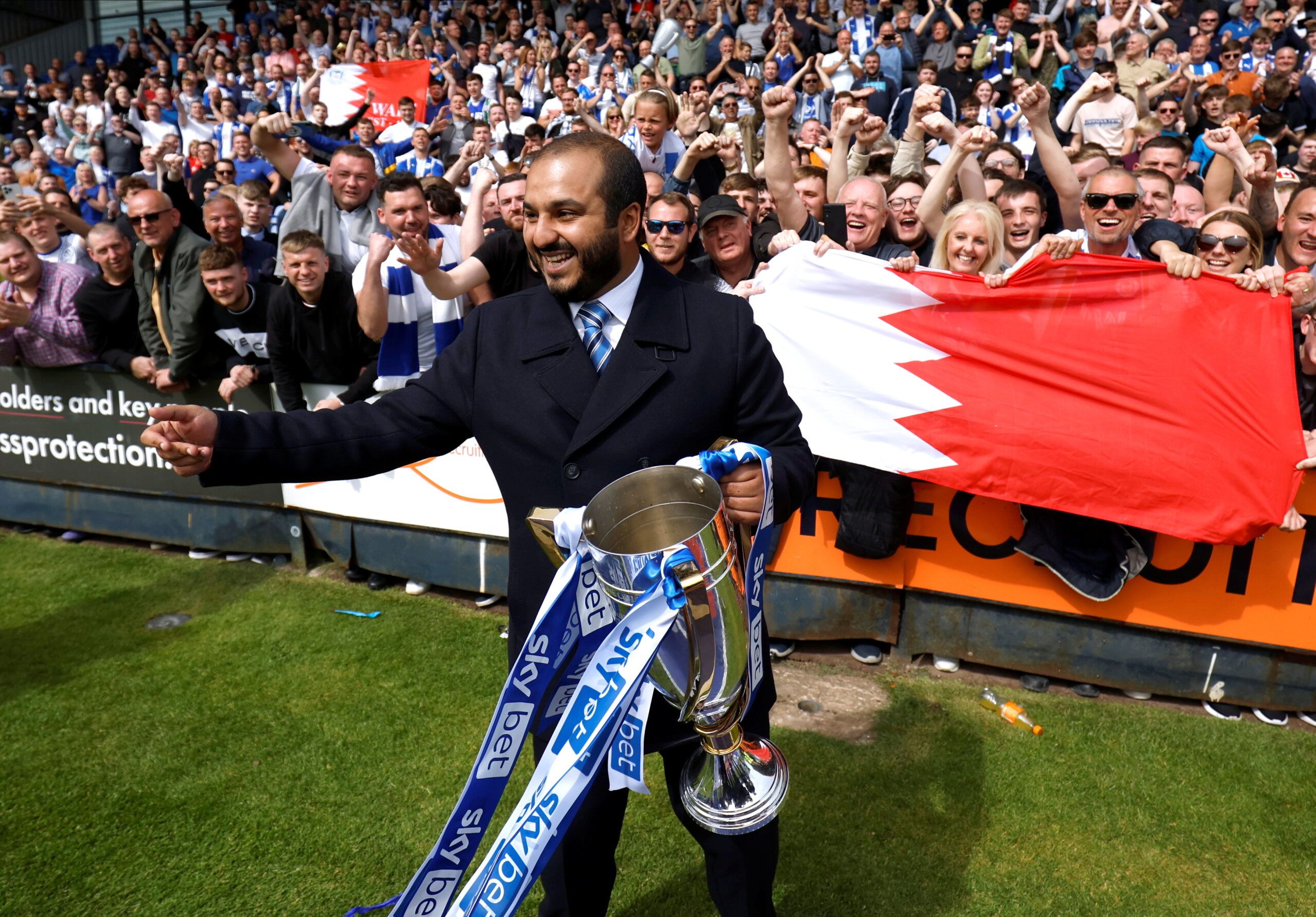 Soccer Football - League One - Shrewsbury Town v Wigan - Montgomery Waters Meadow, Shrewbury, Britain - April 30, 2022 Wigan Athletic chairman Talal Al-Hammad celebrates winning League One with the trophy    Action Images/Jason Cairnduff  EDITORIAL USE ONLY. No use with unauthorized audio, video, data, fixture lists, club/league logos or 