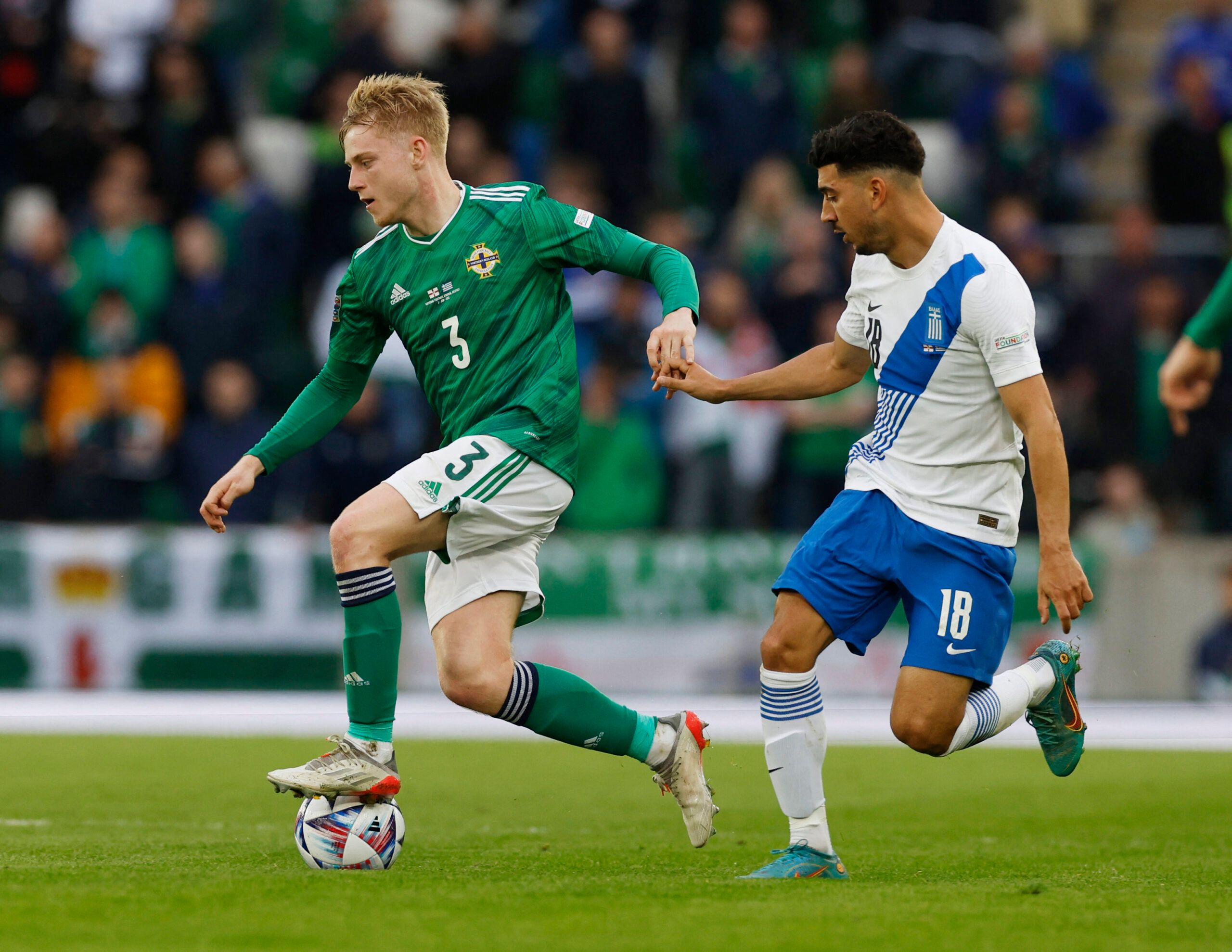 Soccer Football - UEFA Nations League - Group J - Northern Ireland v Greece - Windsor Park, Belfast, Northern Ireland, Britain - June 2, 2022 Northern Ireland's Paddy Lane in action with Greece's Dimitrios Limnios Action Images via Reuters/Jason Cairnduff