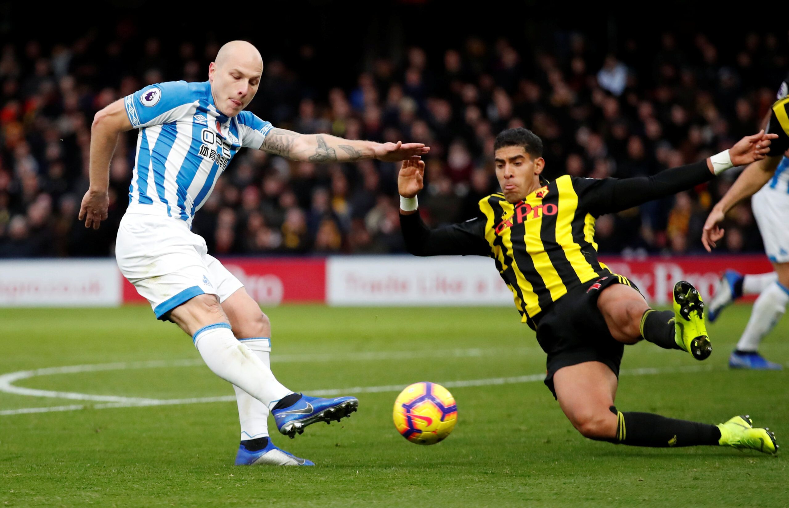 Soccer Football - Premier League - Watford v Huddersfield Town - Vicarage Road, Watford, Britain - October 27, 2018  Huddersfield Town's Aaron Mooy in action with Watford's Adam Masina        Action Images via Reuters/Andrew Boyers  EDITORIAL USE ONLY. No use with unauthorized audio, video, data, fixture lists, club/league logos or 